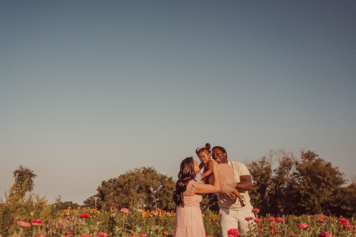 Romantic sunset portrait in a colorful flower garden.