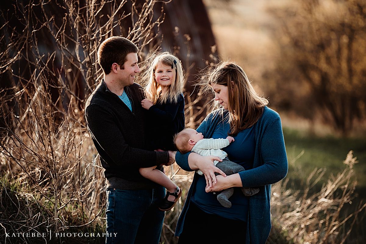 Family portrait session in natural setting with golden hour lighting.