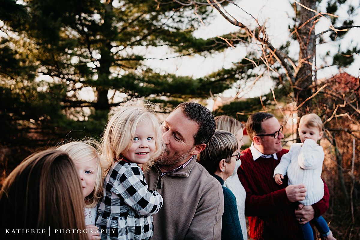 Intimate family moment captured during golden hour among pine trees in autumn.