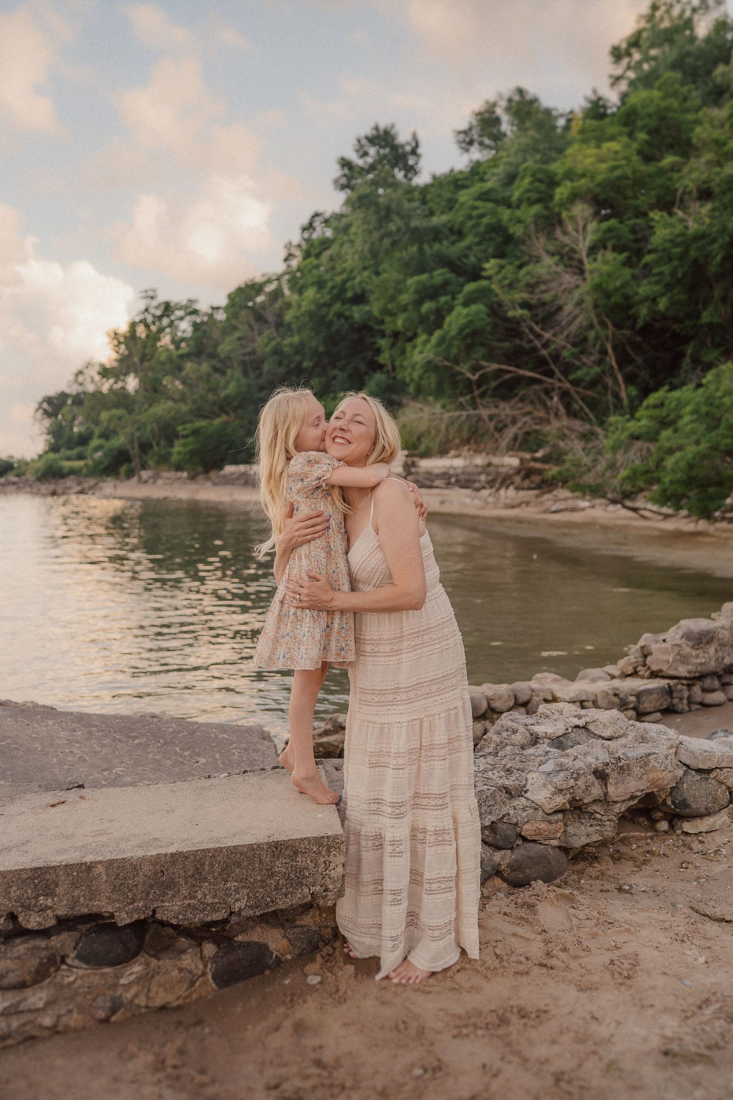 A heartwarming family moment captured in a series of candid portraits along a peaceful beach at sunset.