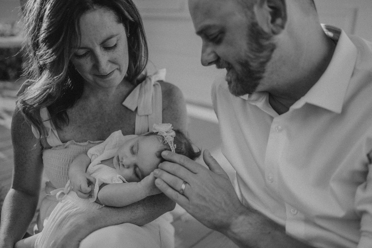 Tender black and white moment captured during a lifestyle newborn photoshoot.