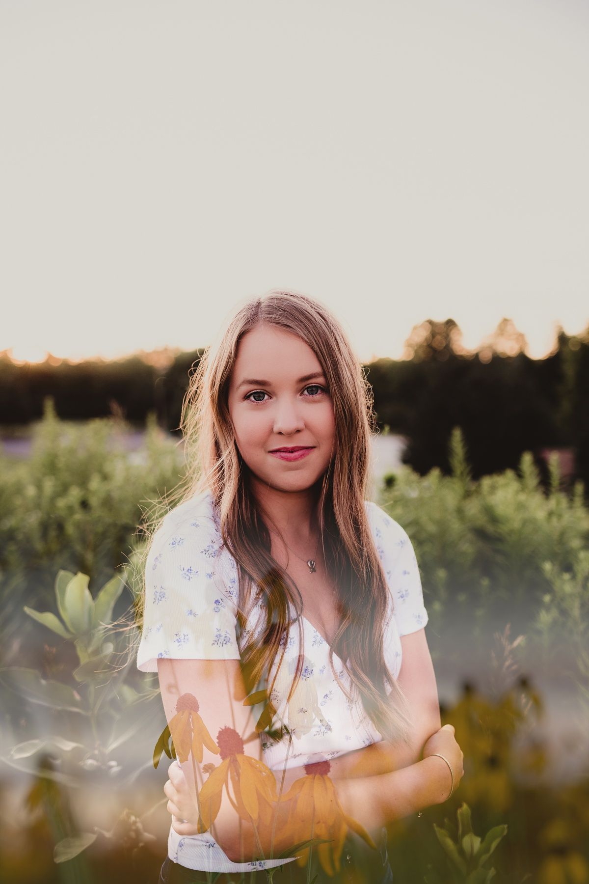 A dreamy summer portrait in a floral print top at golden hour.