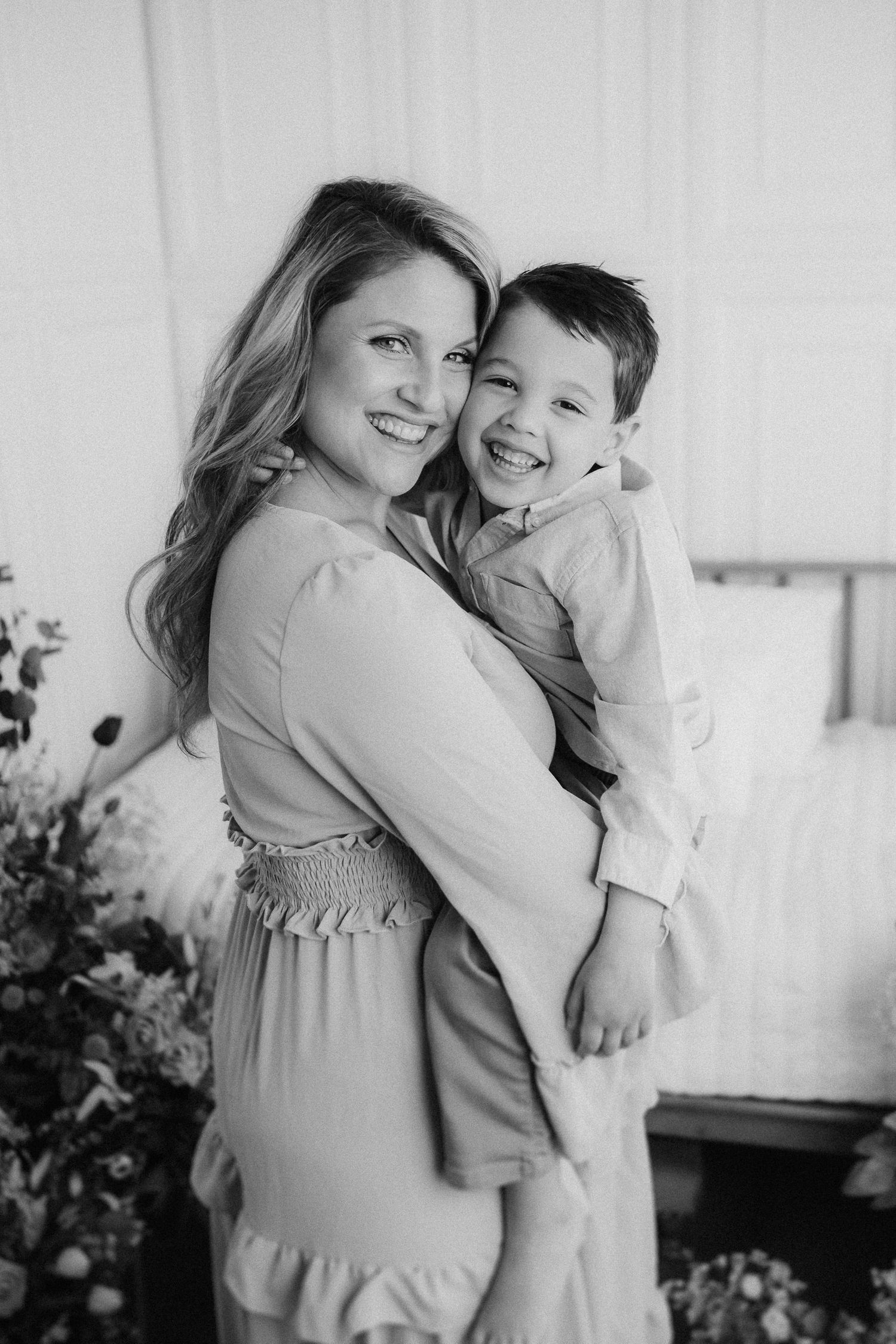 A series of three black and white photos showing joyful embraces between parent and child in casual portrait settings.