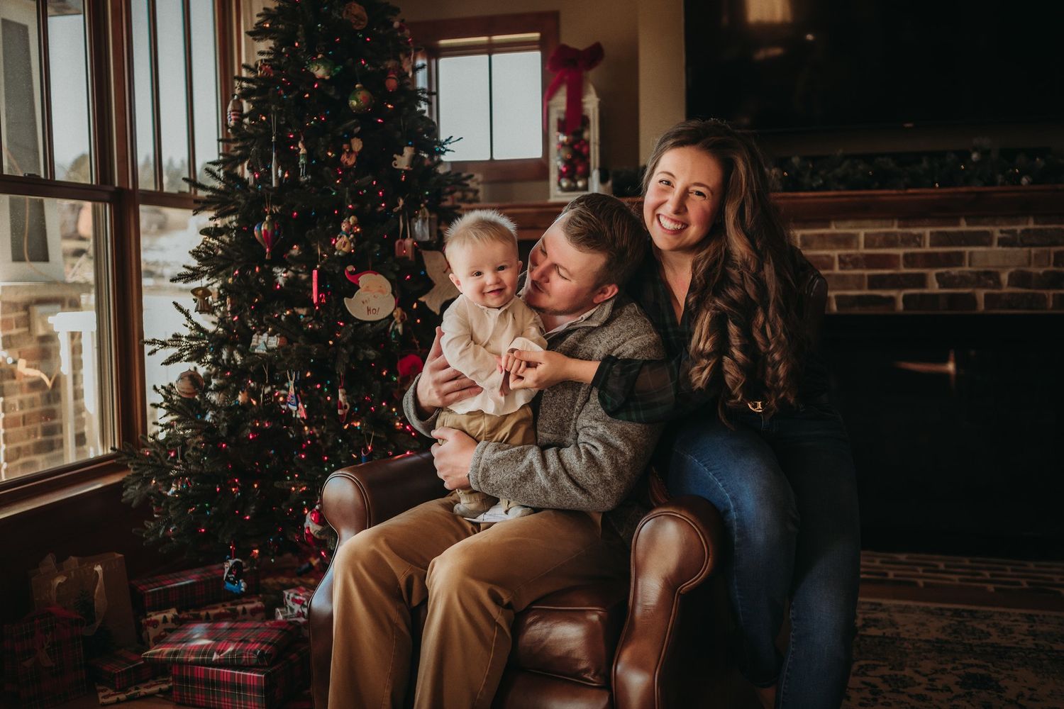 A family shares a candid moment of joy while sitting together during the holiday season.