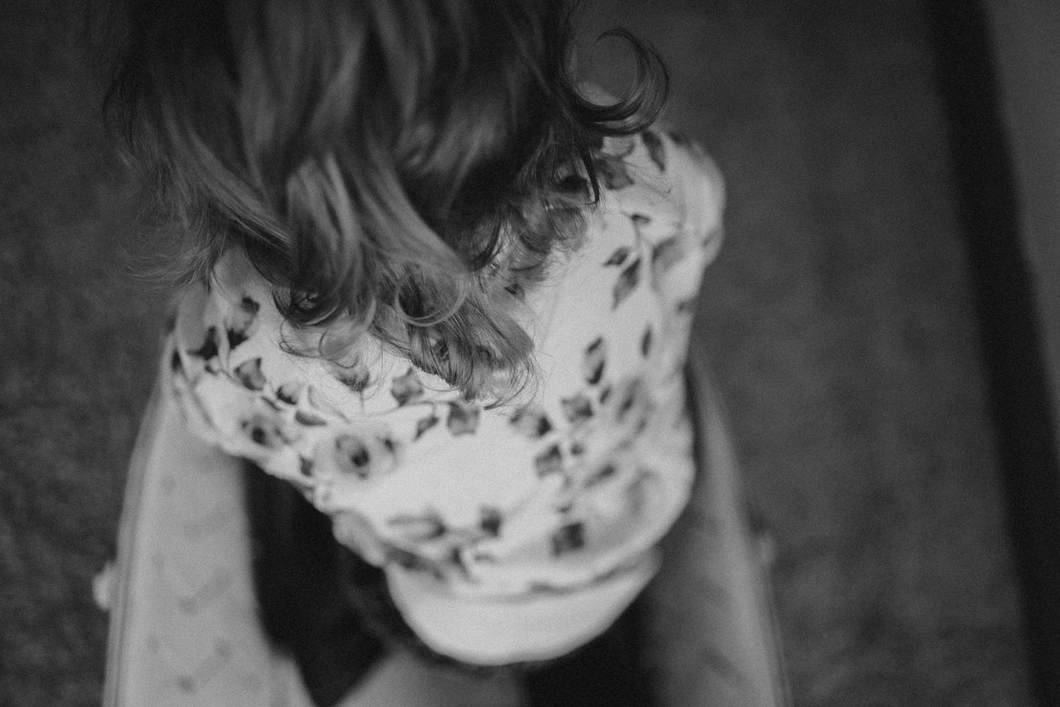 Artistic black and white portrait of a floral dress detail with soft focus effect.