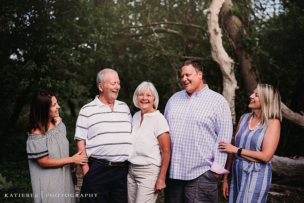 A candid family moment outdoors with multiple generations sharing laughter together.