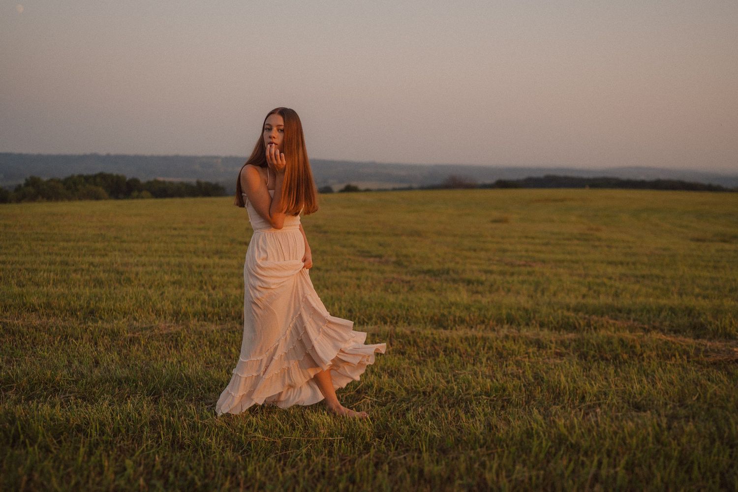 A dreamy outdoor photo shoot in a vast meadow at golden hour.