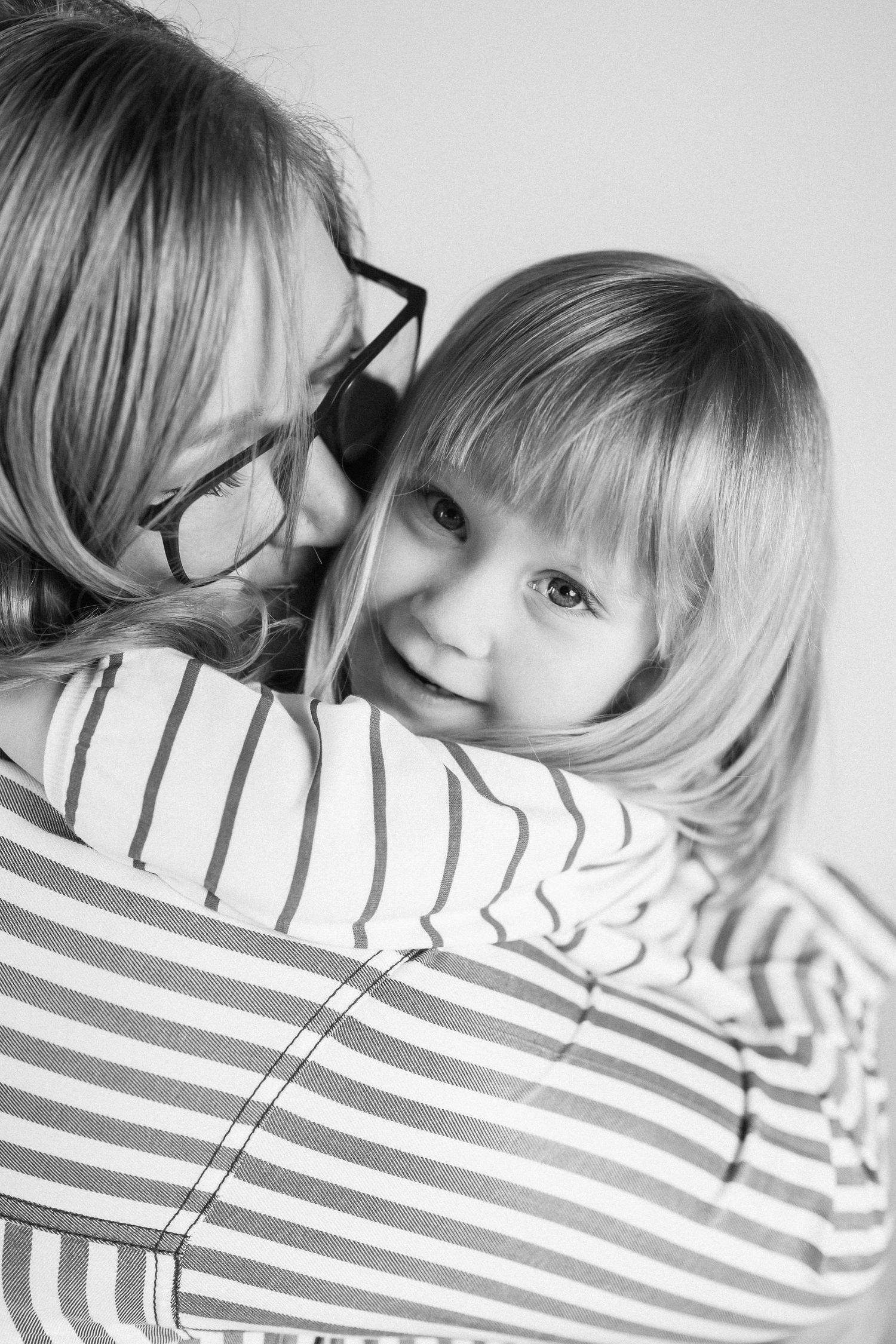 Black and white portrait series featuring someone in a striped shirt against a white background.