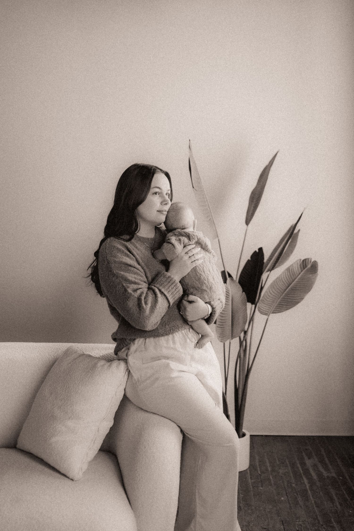 Black and white artistic photo sequence showing a figure in white embracing and interacting with a soft pillow against a wall.