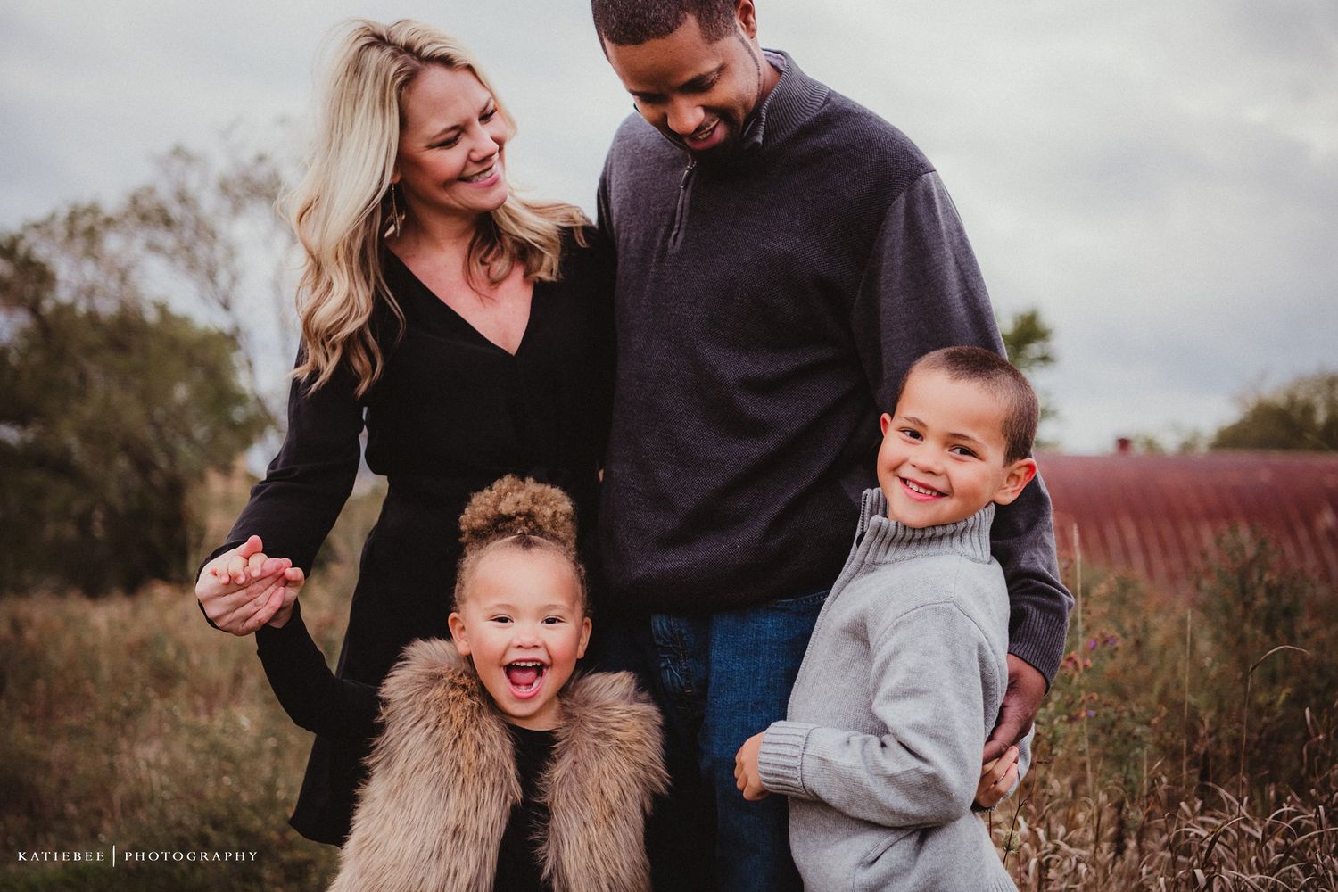 Joyful family interaction captured in candid moment during outdoor photo session.