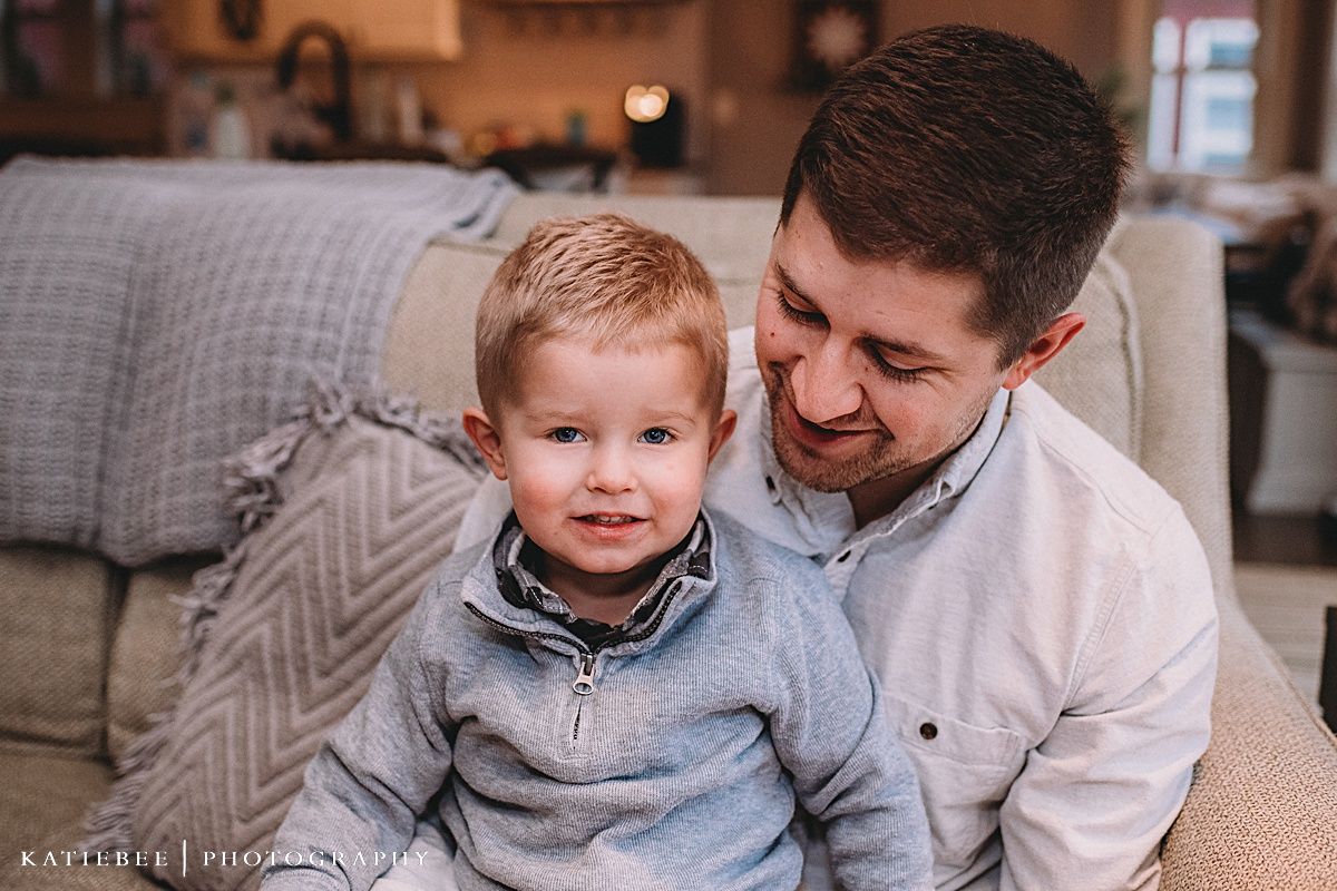 Heartwarming moment shared between two people on a grey couch.