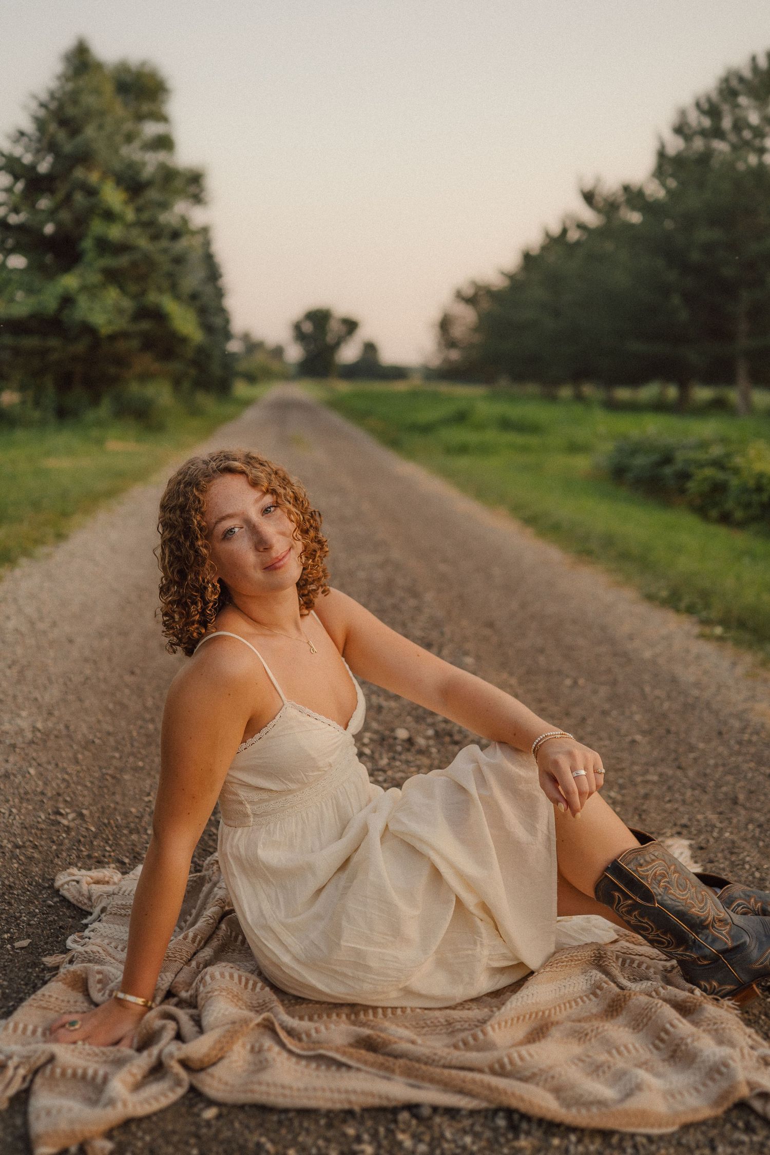 Golden hour portraits on a country road featuring a cream dress and combat boots.