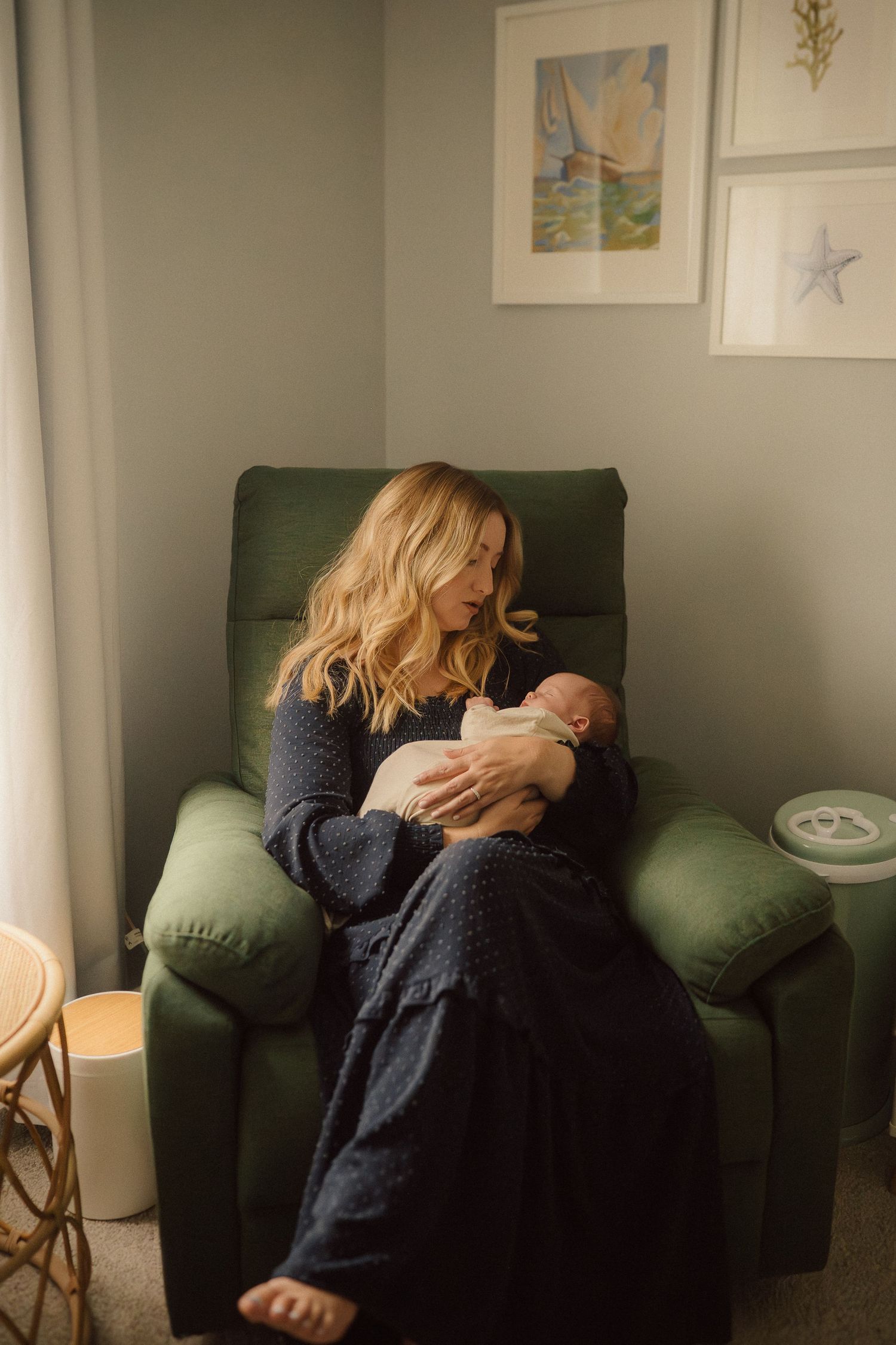 A series of quiet moments captured on a dark green couch against a soft gray wall with framed artwork.