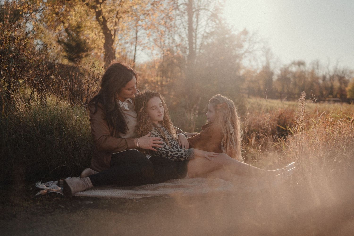 A joyful black and white family photo of people playing together in a field.