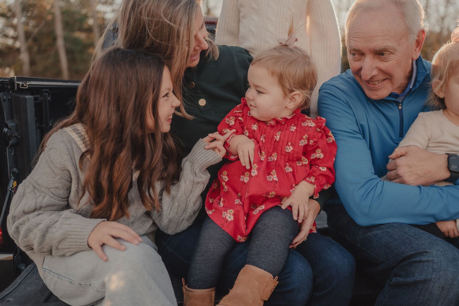 Candid family moments captured during a sunset photoshoot showing natural interactions and laughter.