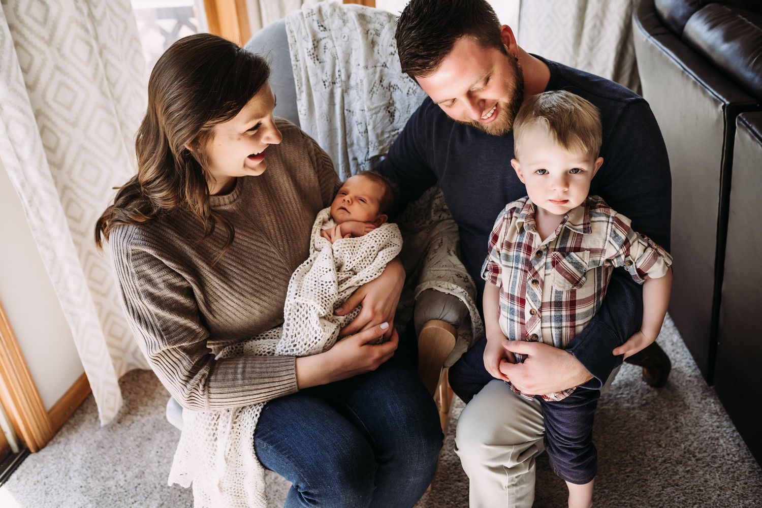 Family shares an intimate moment together in their cozy living room.