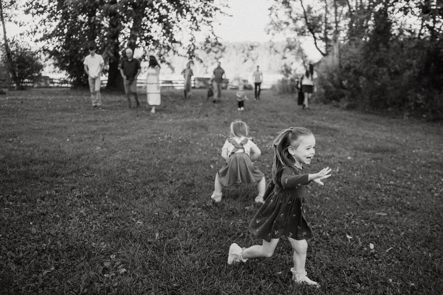 Black and white photo series captures joyful outdoor play and movement in a park setting.