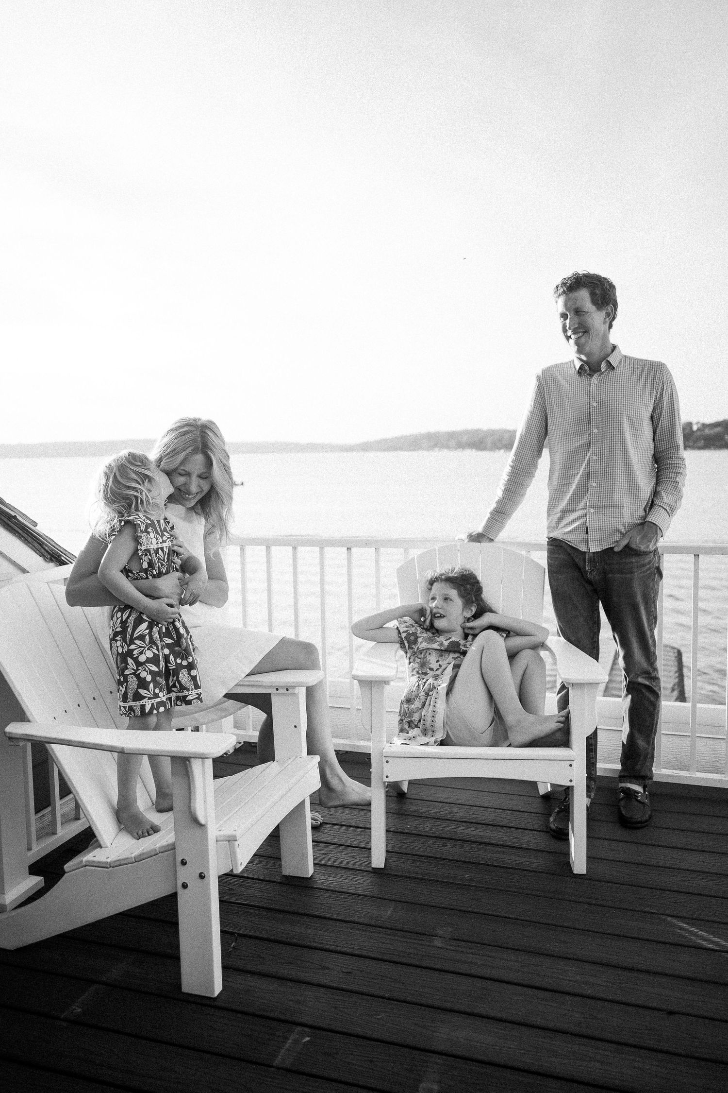 A series of candid moments on a wooden deck overlooking a waterfront, showing casual interaction and conversation.