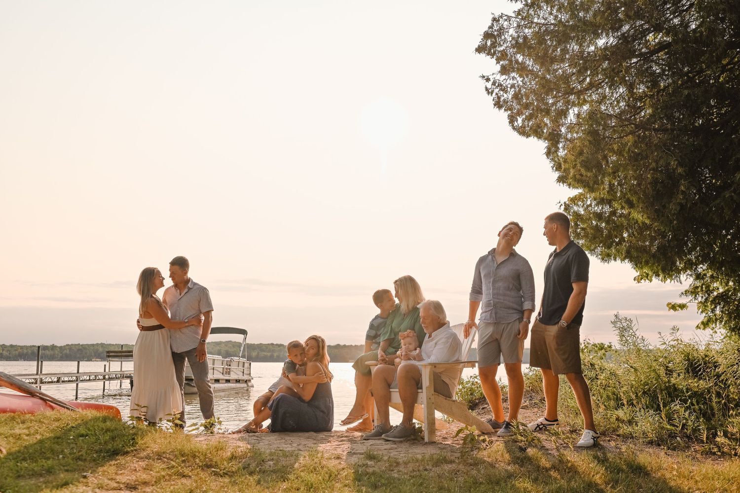 Group enjoying sunset views from a scenic overlook by the water.