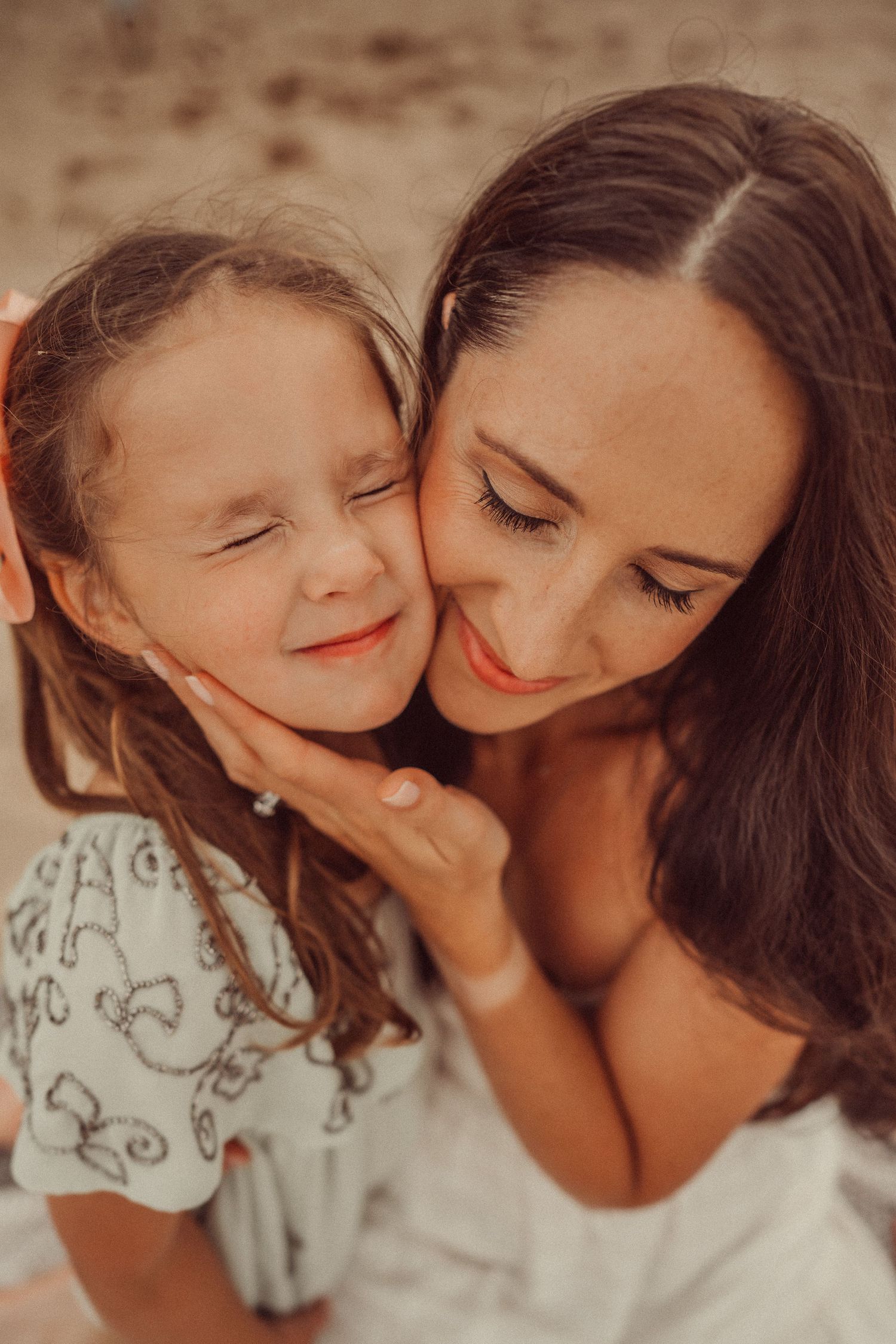 A heartwarming close-up moment between two people with joyful expressions at the beach.