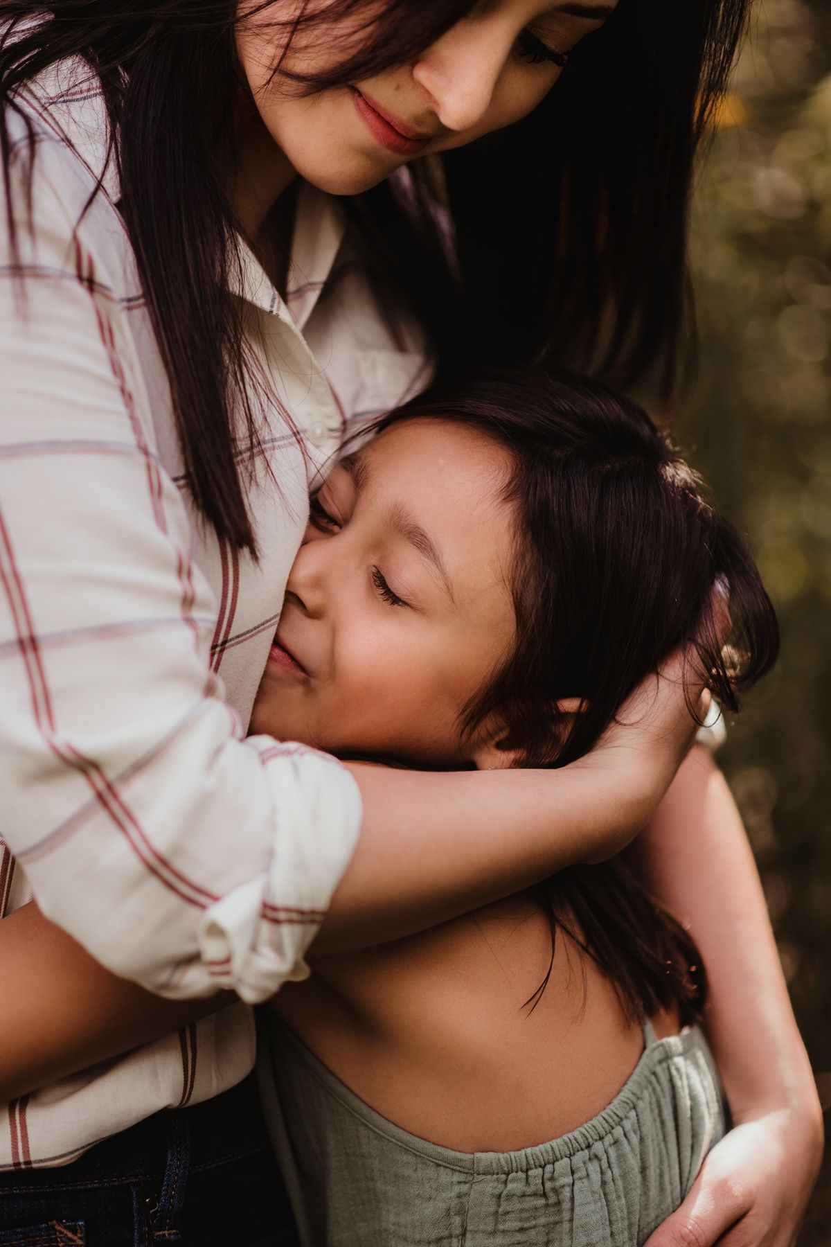 Candid embrace between parent and child showing intimate connection and love.