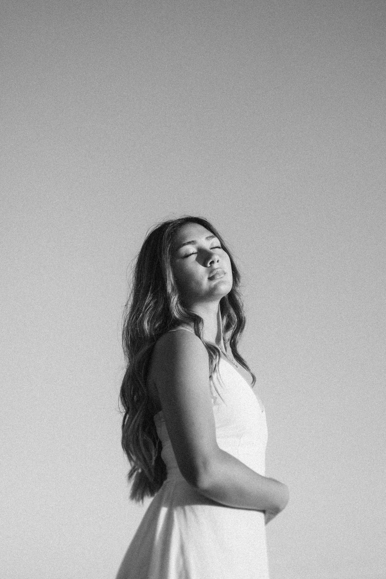 Artistic black and white portrait series showing graceful movement against a minimalist background.
