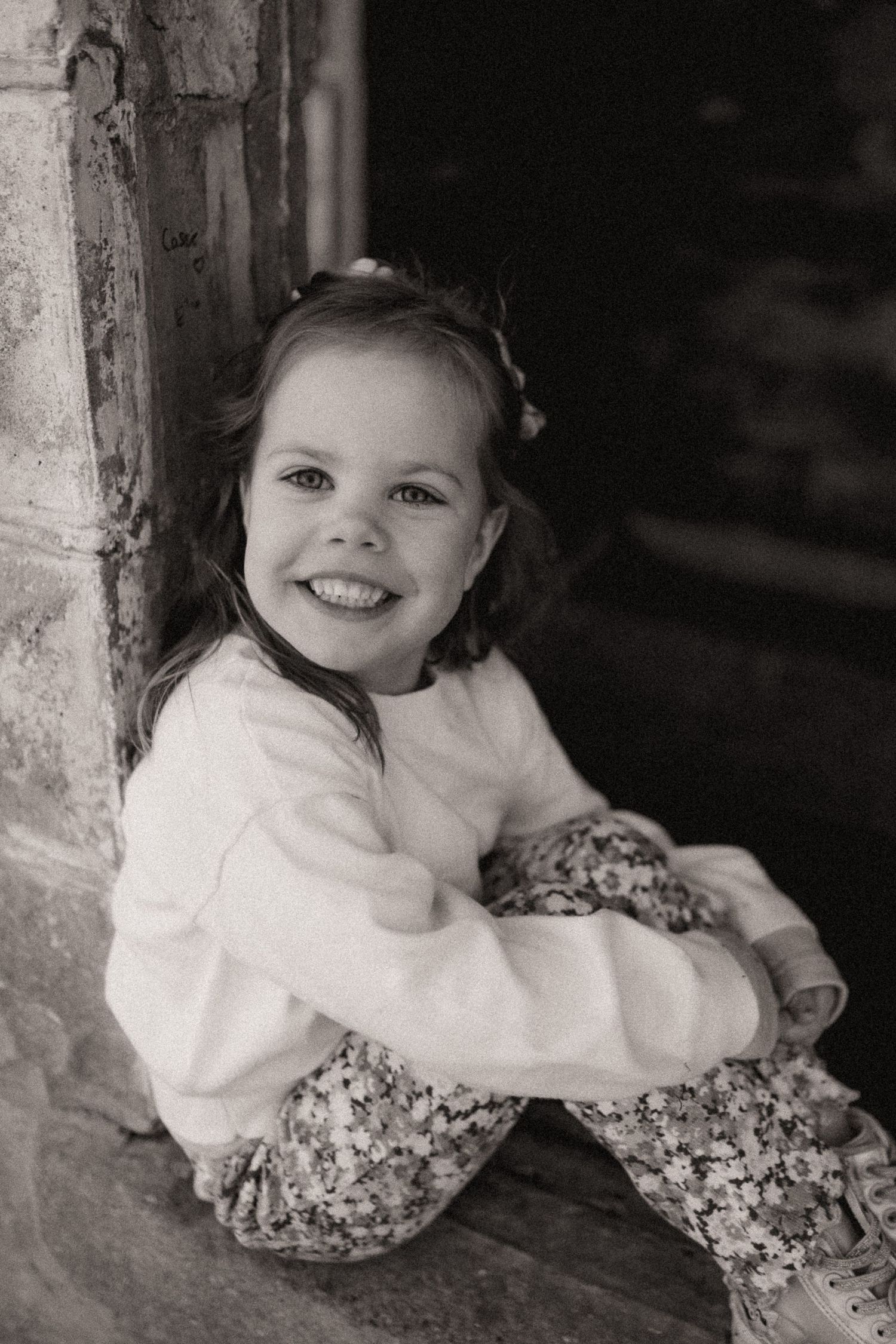 A series of black and white portraits showing sweet expressions and smiles.