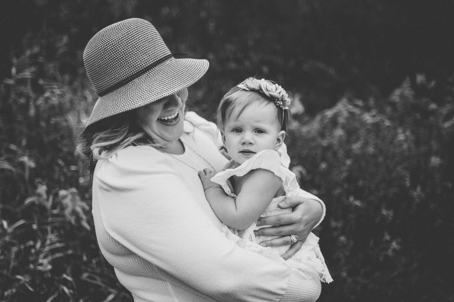 Sweet embrace captured in black and white outdoor portrait.