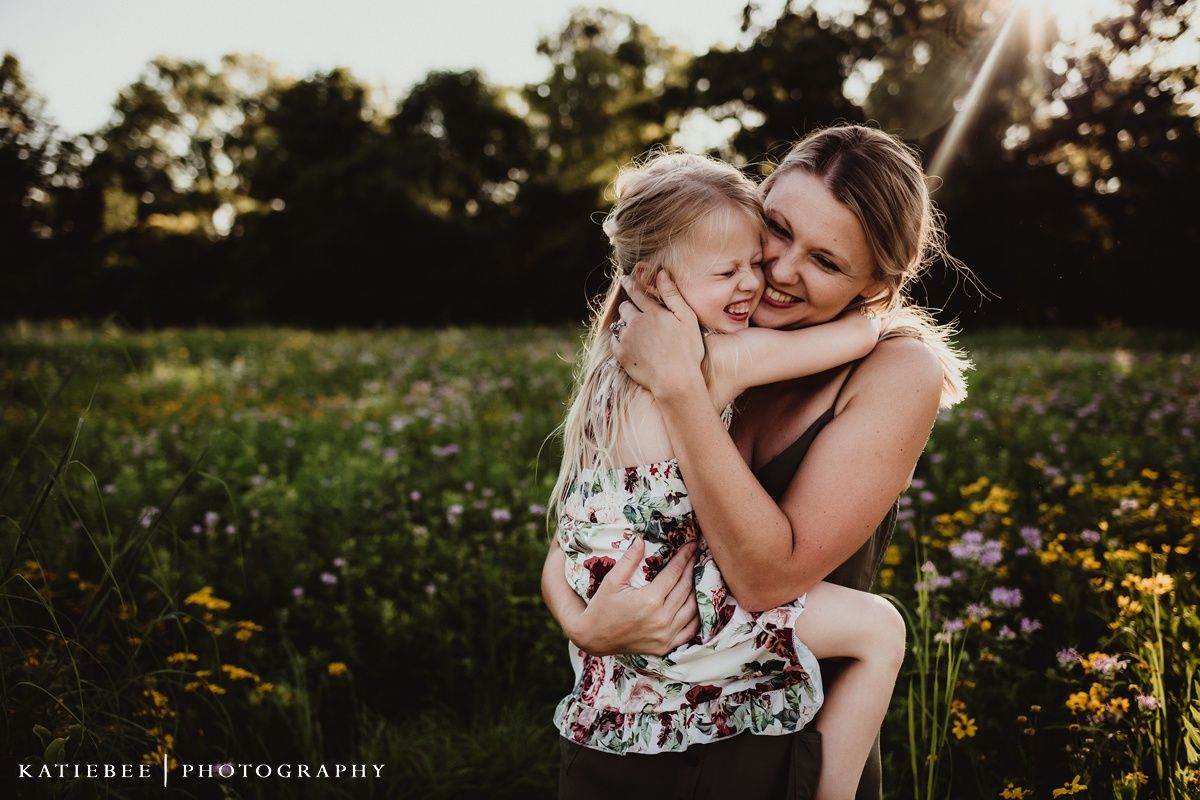Intimate moment captured during sunset in a meadow filled with yellow flowers.