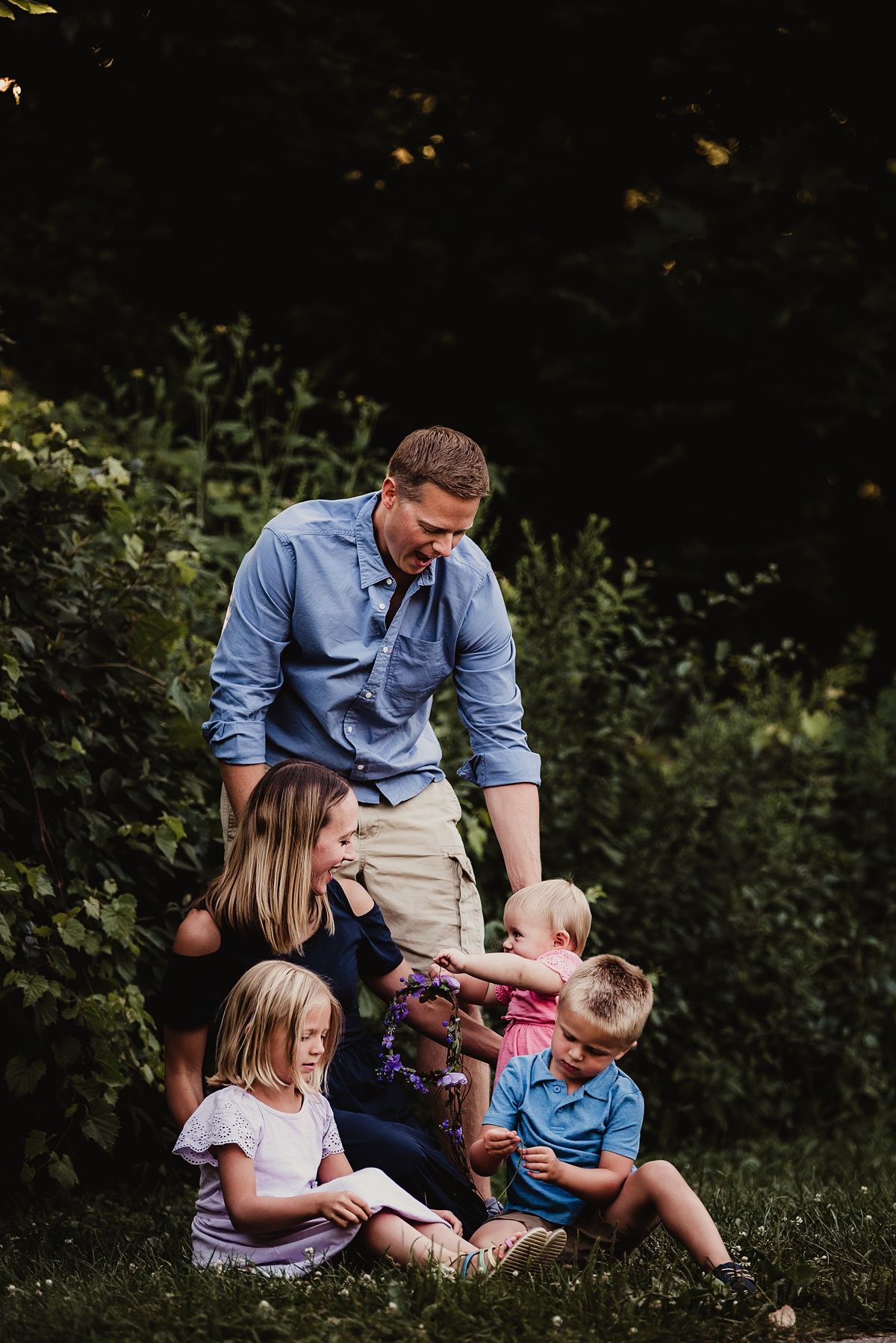 Family gathered together outdoors during casual portrait session.
