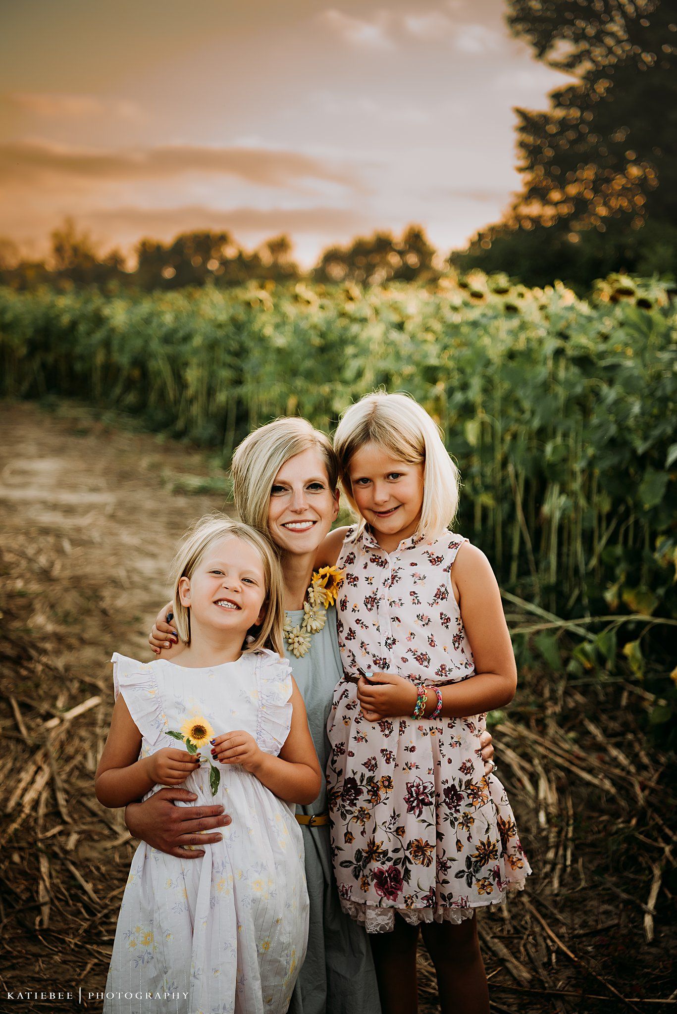 Sunset portrait in a sunflower field with light-filled warmth creating a magical golden hour moment.