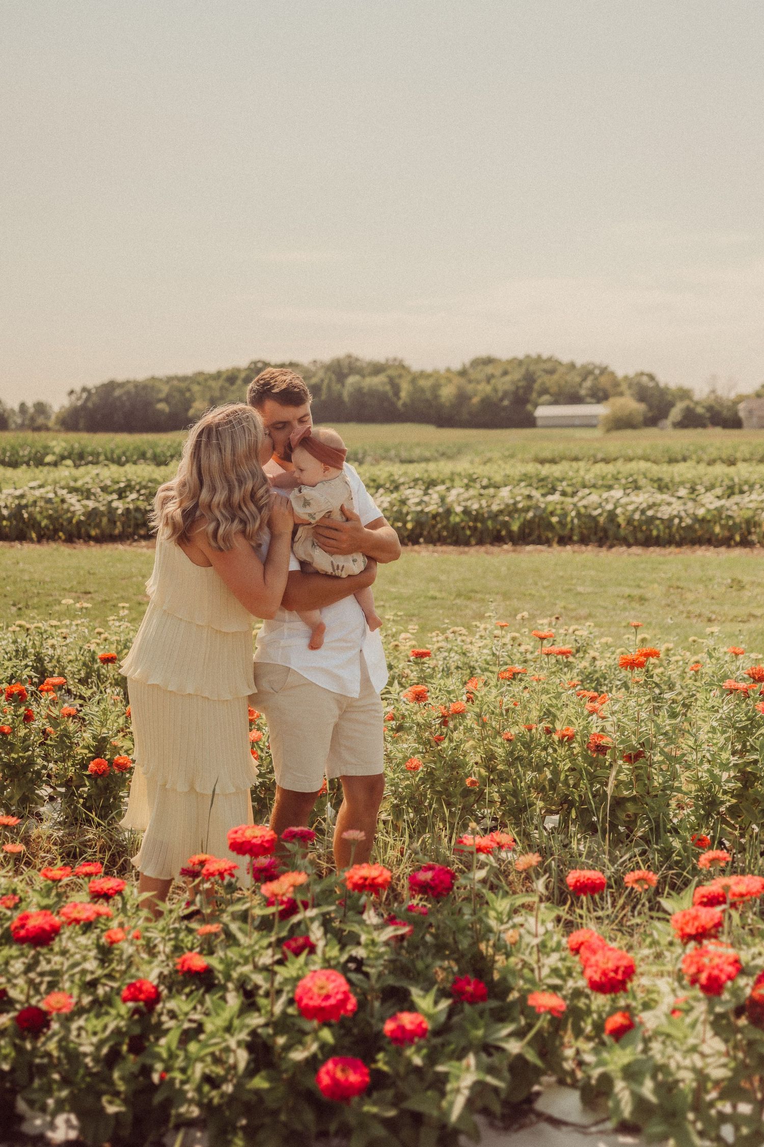 A golden hour family portrait in a field of red poppies.