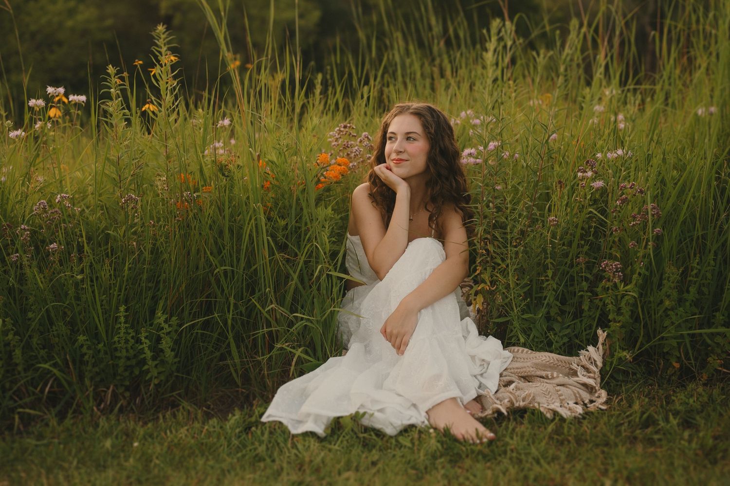 Whimsical portrait in a wildflower meadow with soft evening light.