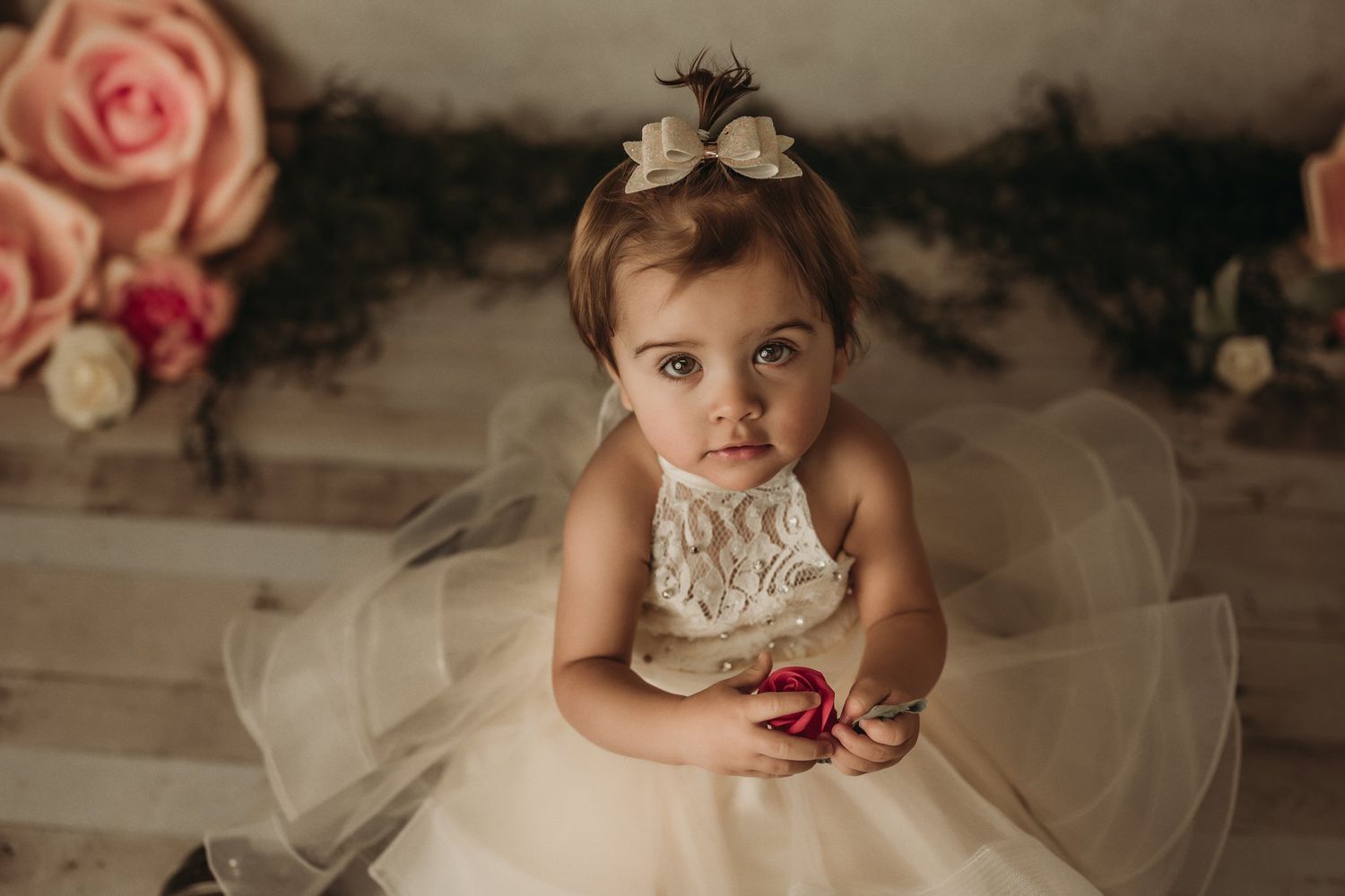 Vintage-inspired portrait with pink roses and white tulle dress.