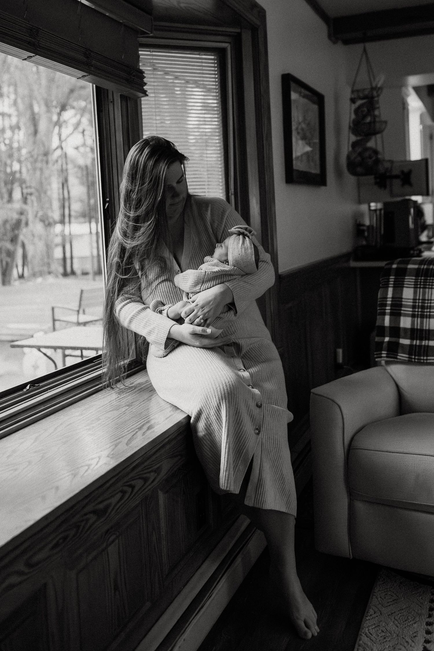 A tender black and white photo series showing a moment by a window with soft natural light.