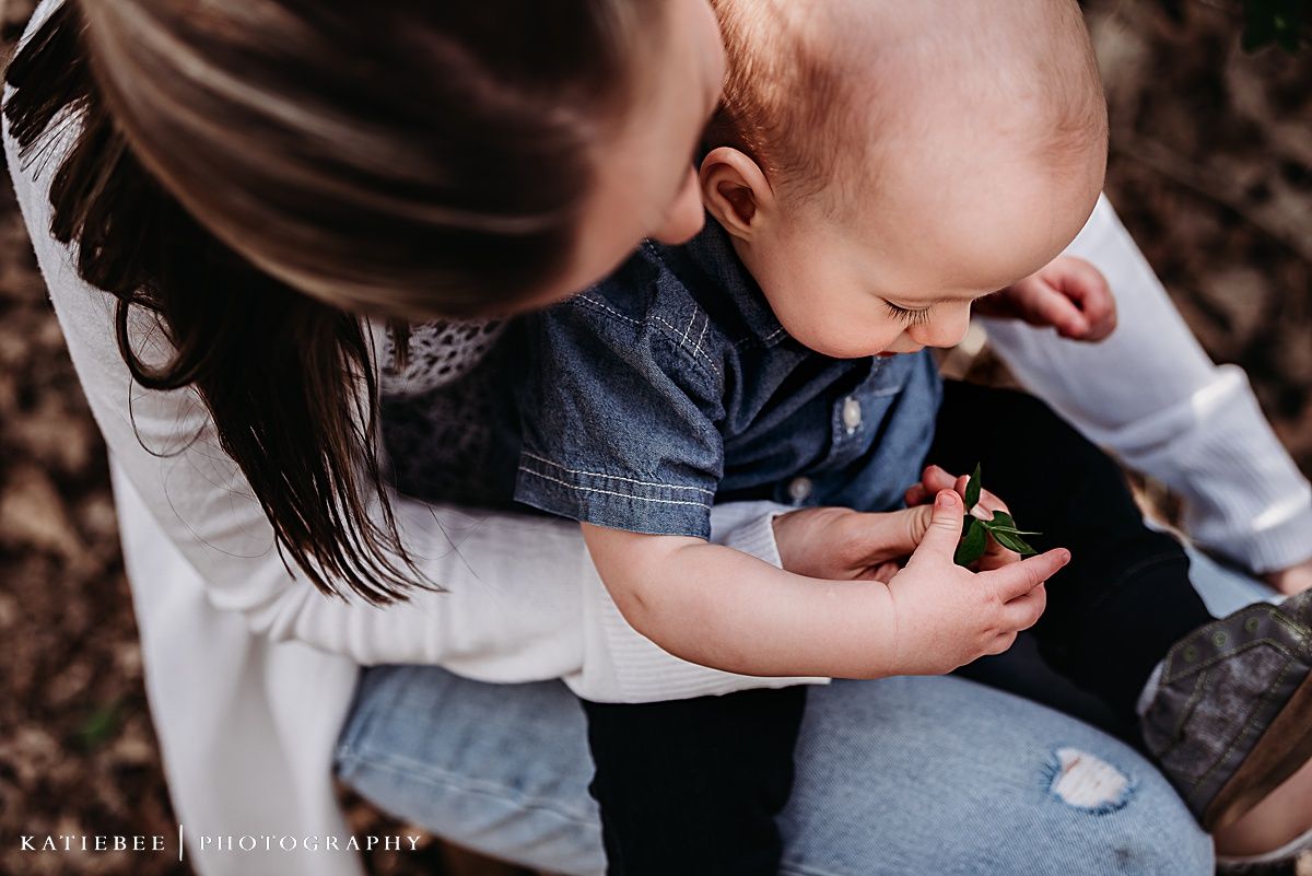 Mother and child examining something interesting in nature.