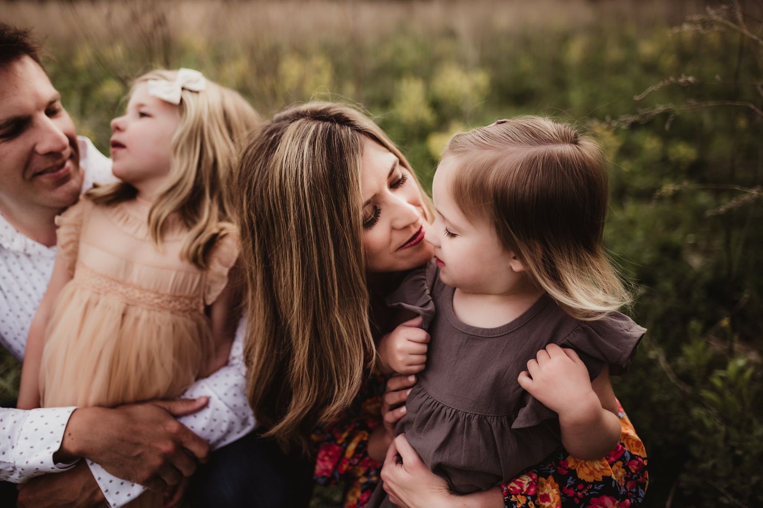 Joyful family moment captured outdoors during sunset with natural scenery.