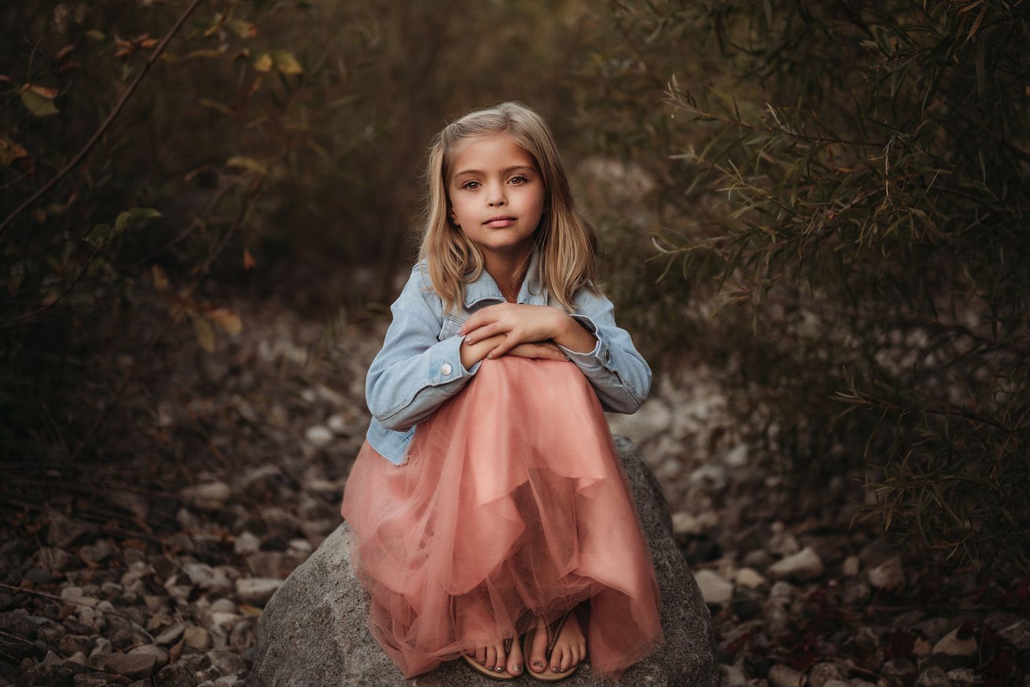 A contemplative moment captured on a rock in a natural outdoor setting.