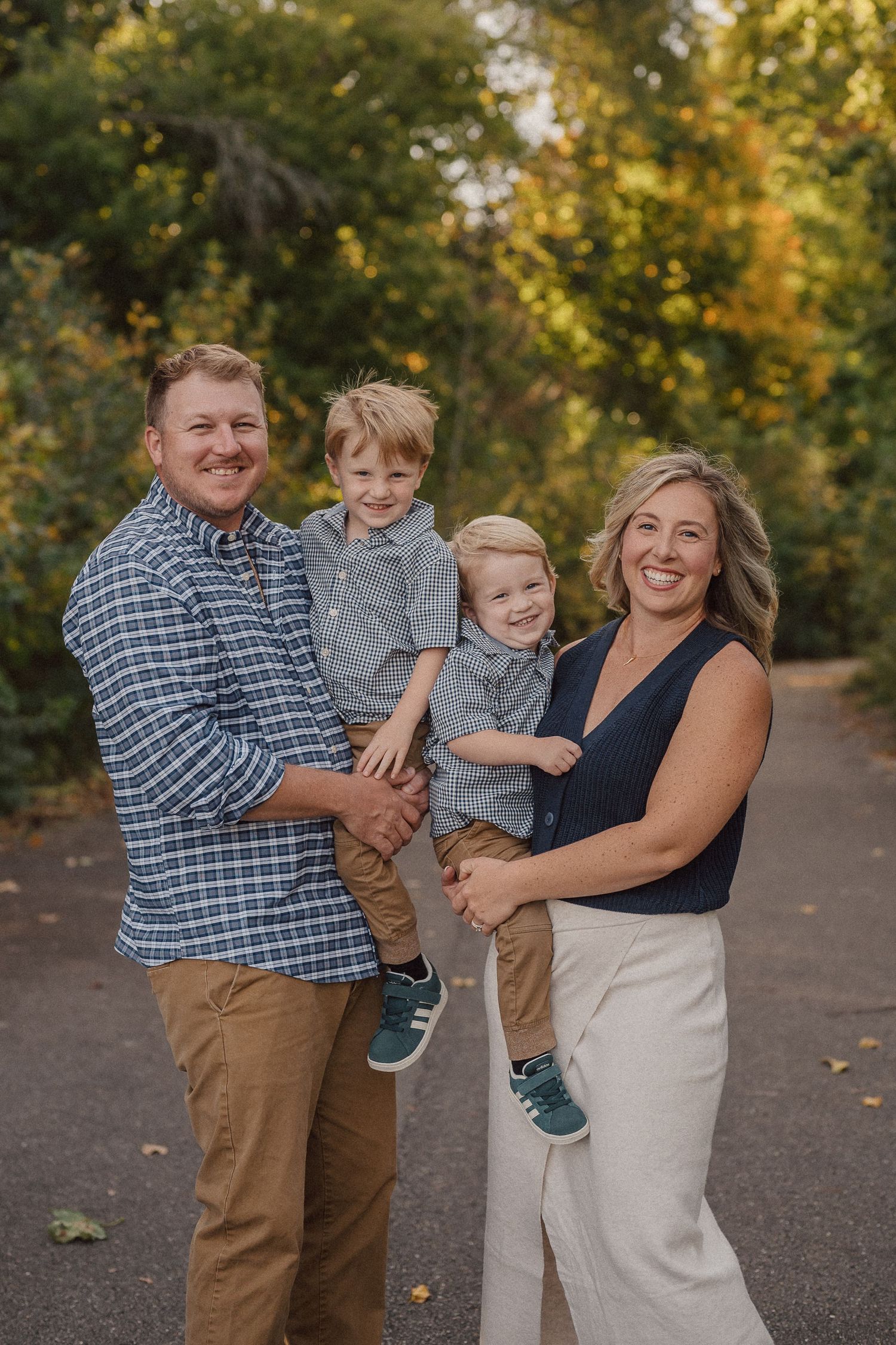 A family shares joyful moments together outdoors on a sunny autumn day.