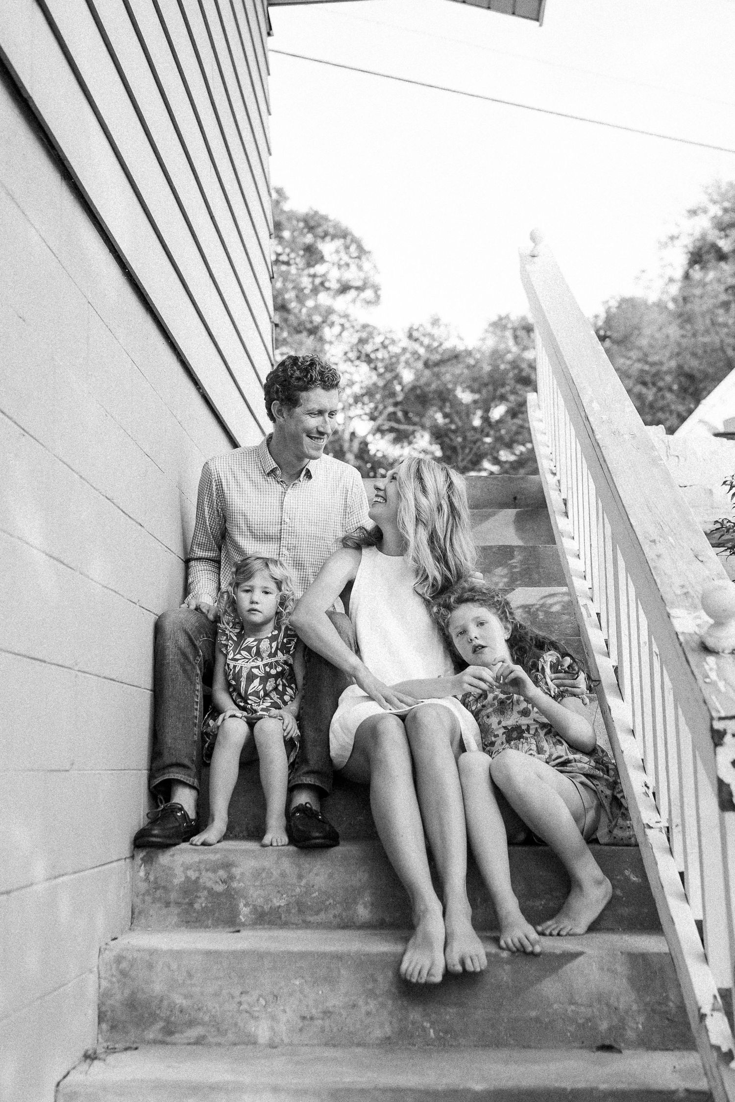 Multiple candid black and white photos showing playful moments on concrete steps outdoors.