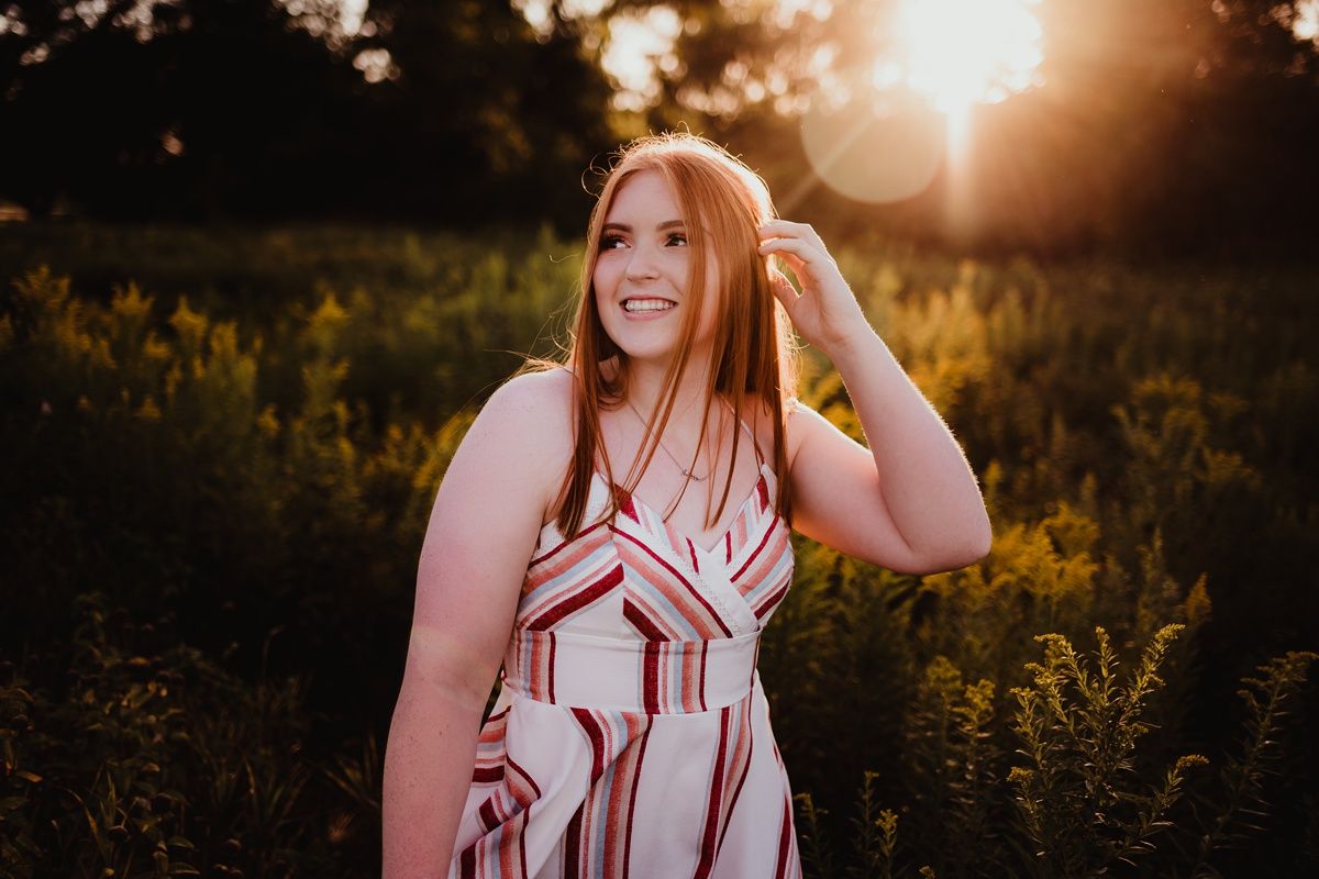 Summer portrait in patterned dress during golden hour.