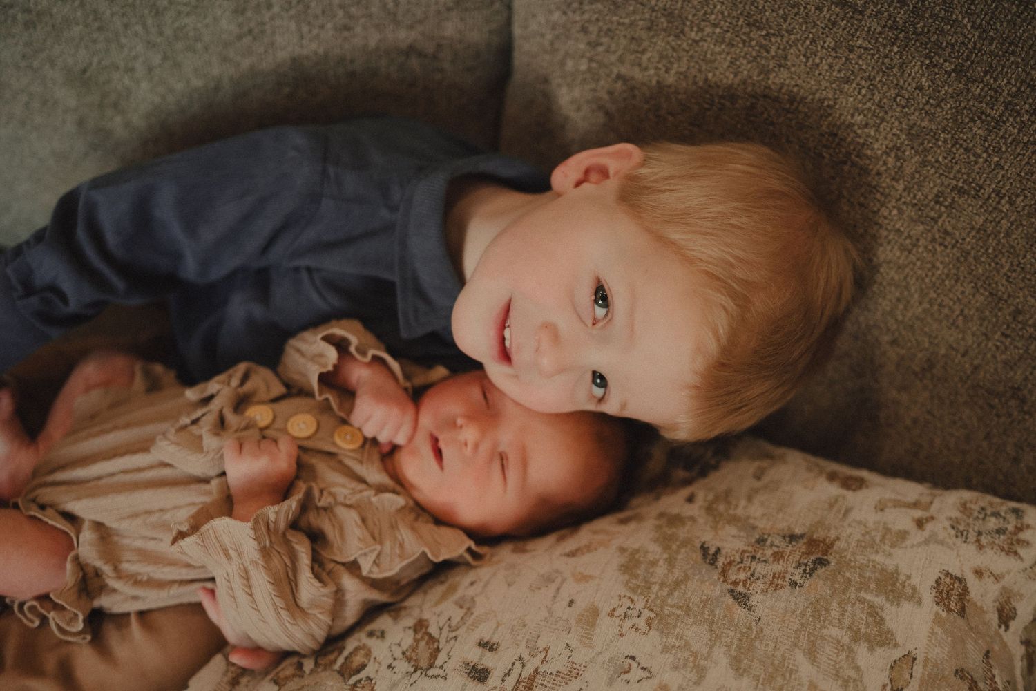 A series of intimate lifestyle photos showing tender family moments on a couch in muted tones.