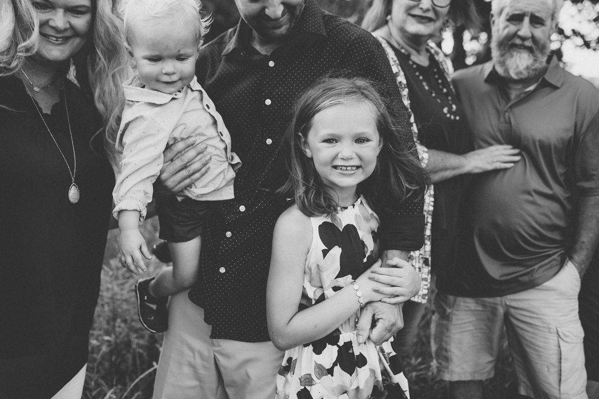 Black and white portrait of extended family gathered outdoors.