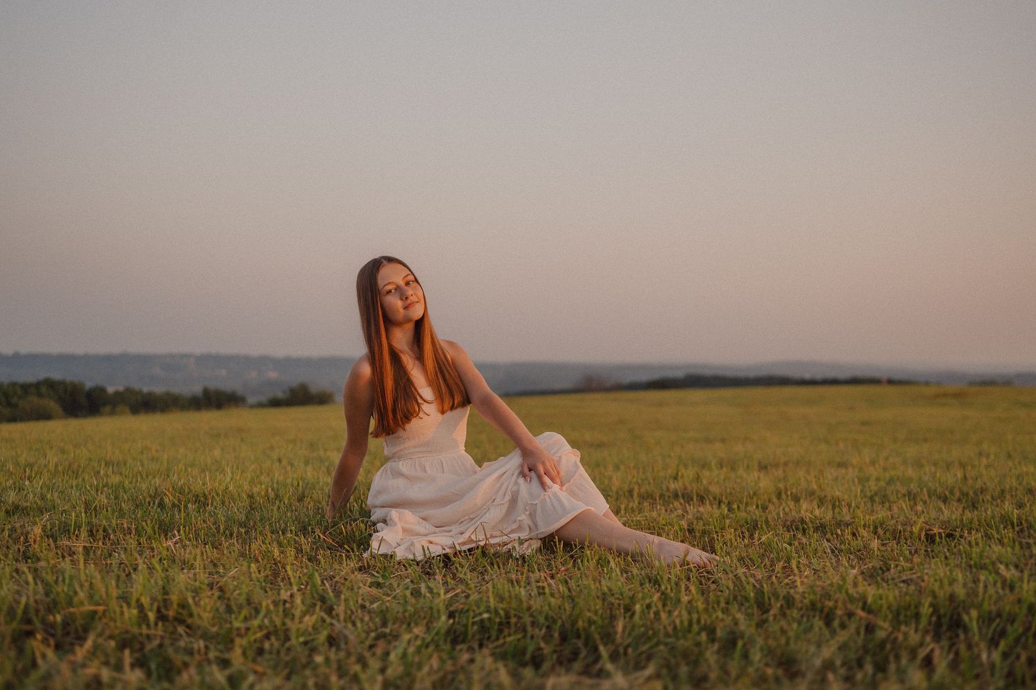 Seven serene images of a woman in a white dress posing gracefully in a golden summer wheat field at sunset.