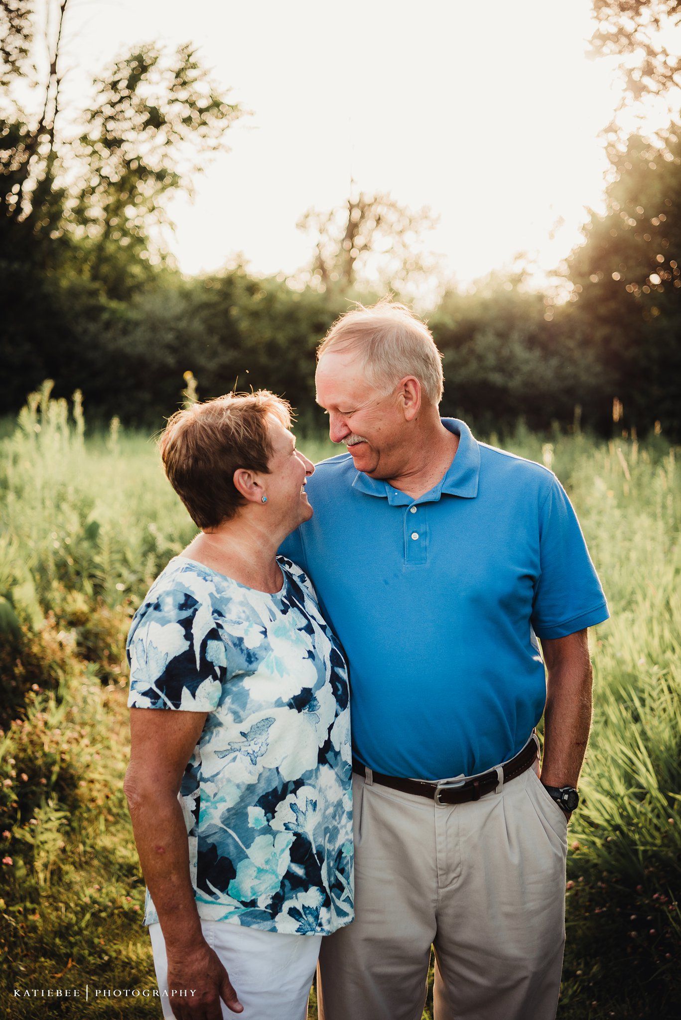 Senior couple sharing an intimate moment outdoors at sunset.