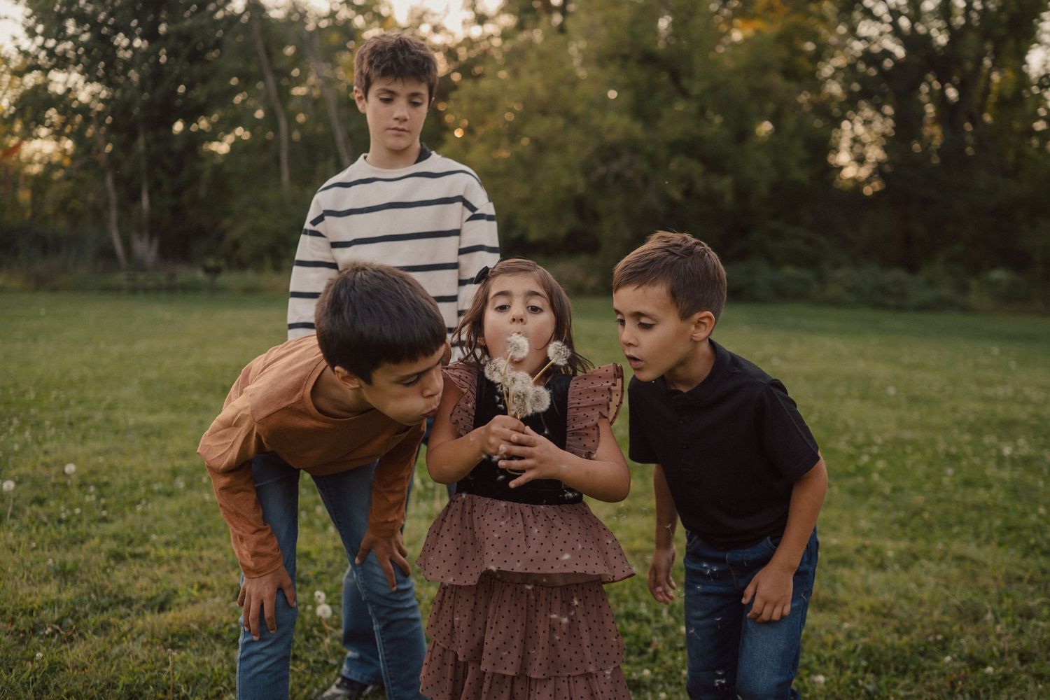 A joyful black and white family photo of people playing together in a field.