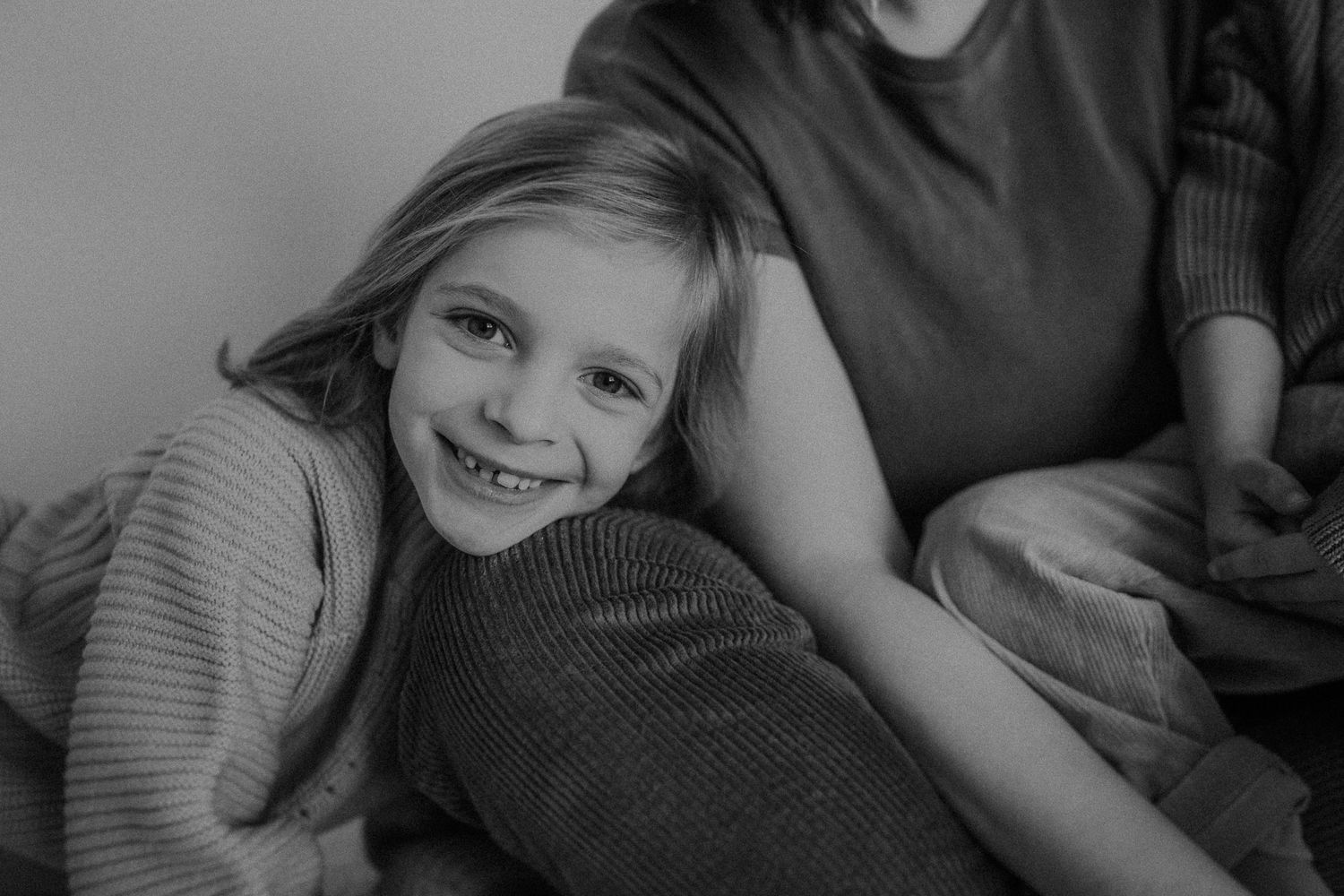 A joyful moment shared during an intimate family photoshoot in black and white.