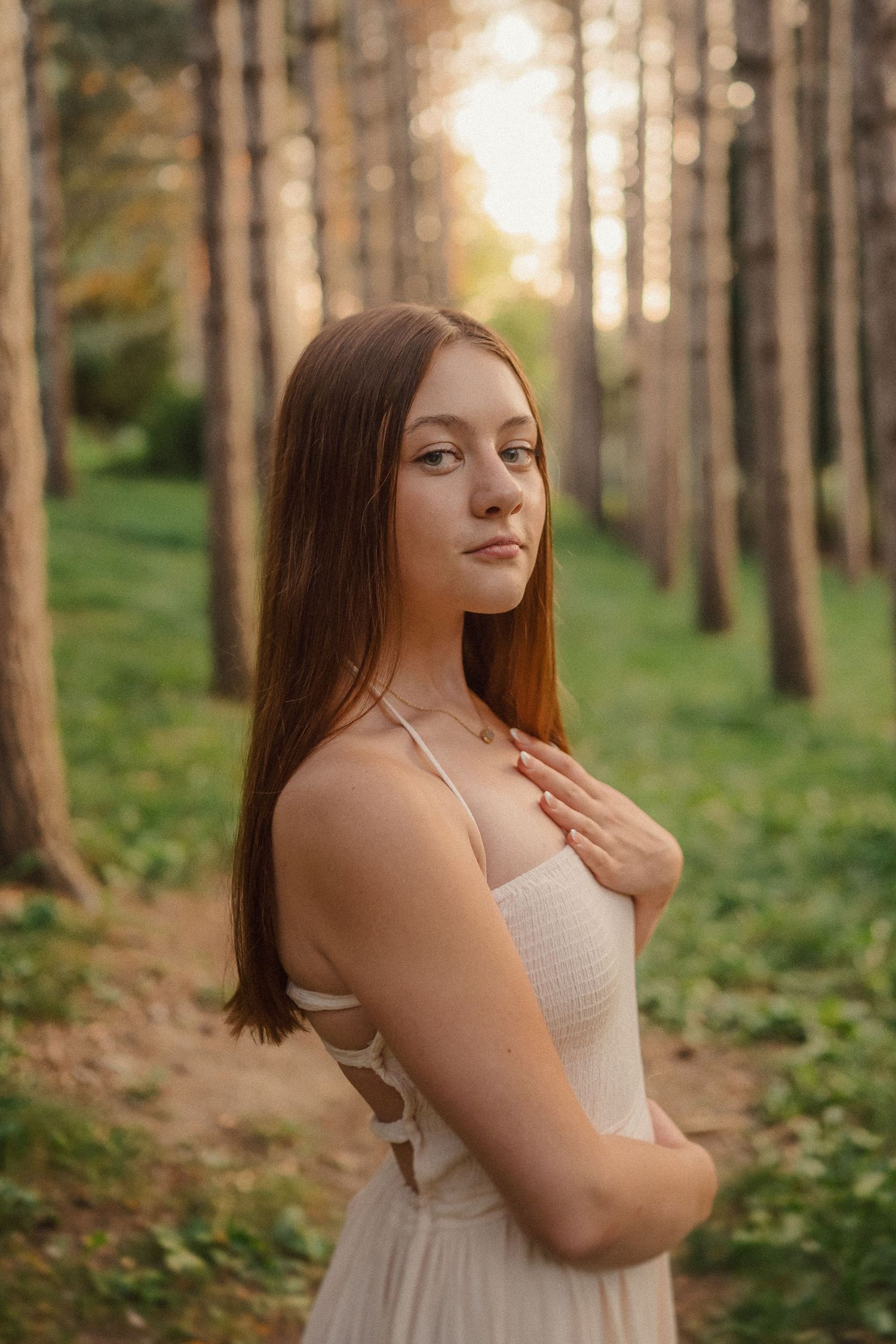A series of ethereal forest portraits showing a figure in a light dress among sunlit trees and greenery.