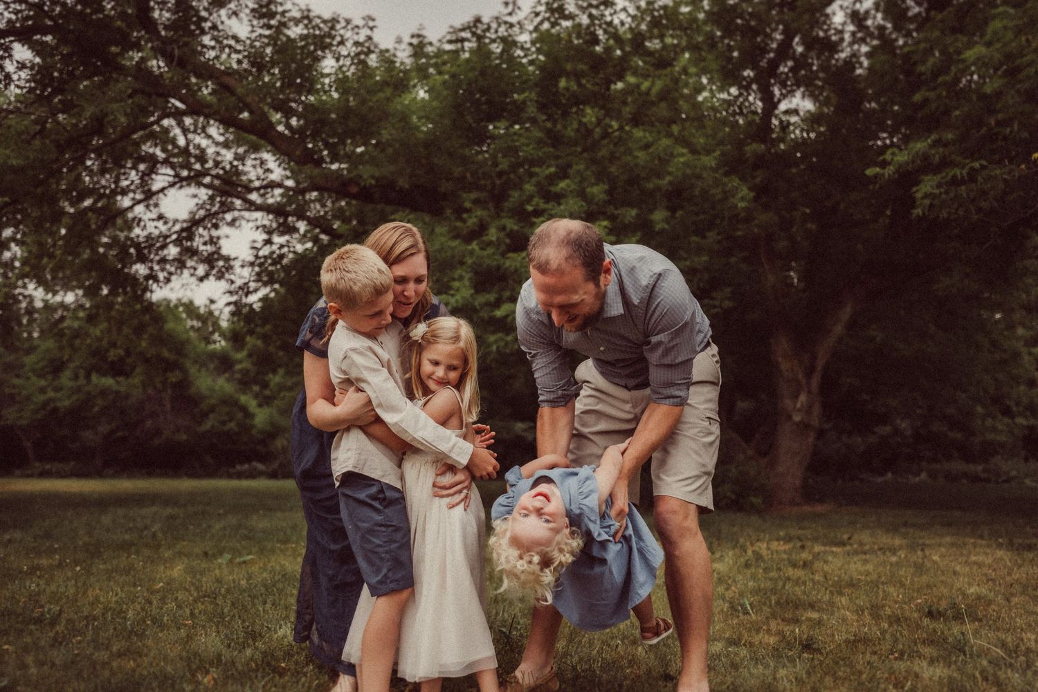 Candid family moment shared in a park setting with natural background.