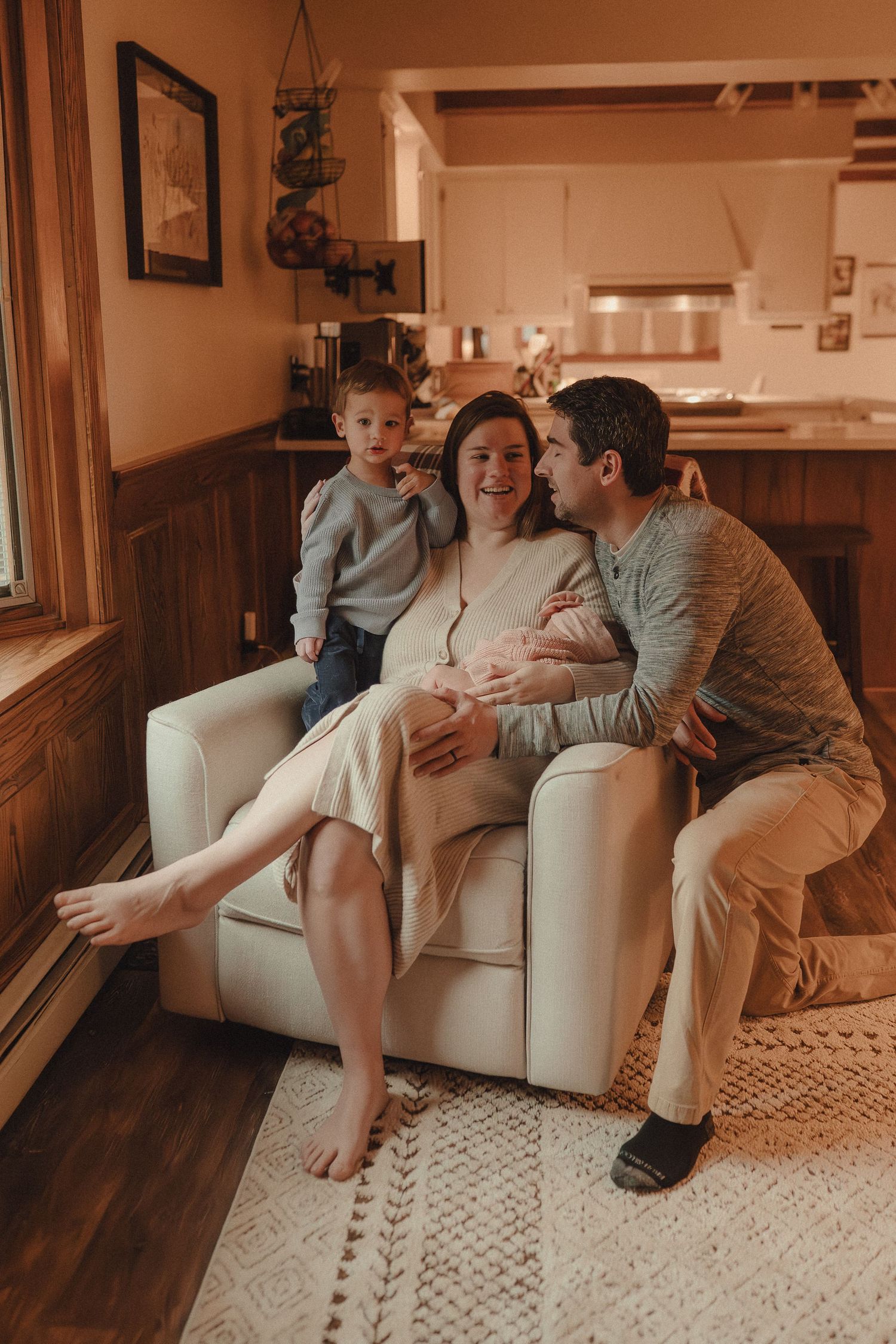 A warm-toned photo series showing intimate moments on a couch with a geometric patterned rug.